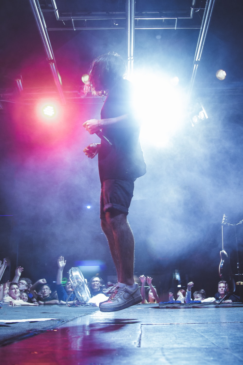 man jumping on stage photo