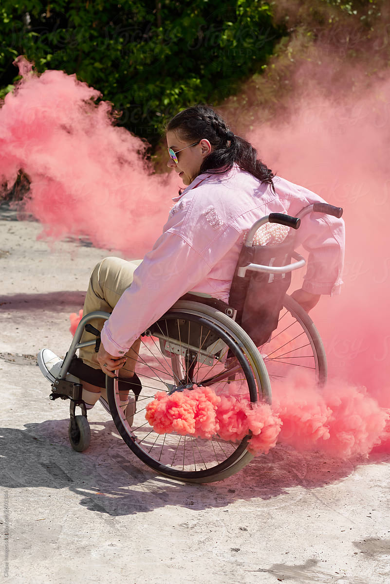Woman In Wheelchair With Pink Smoke Bomb