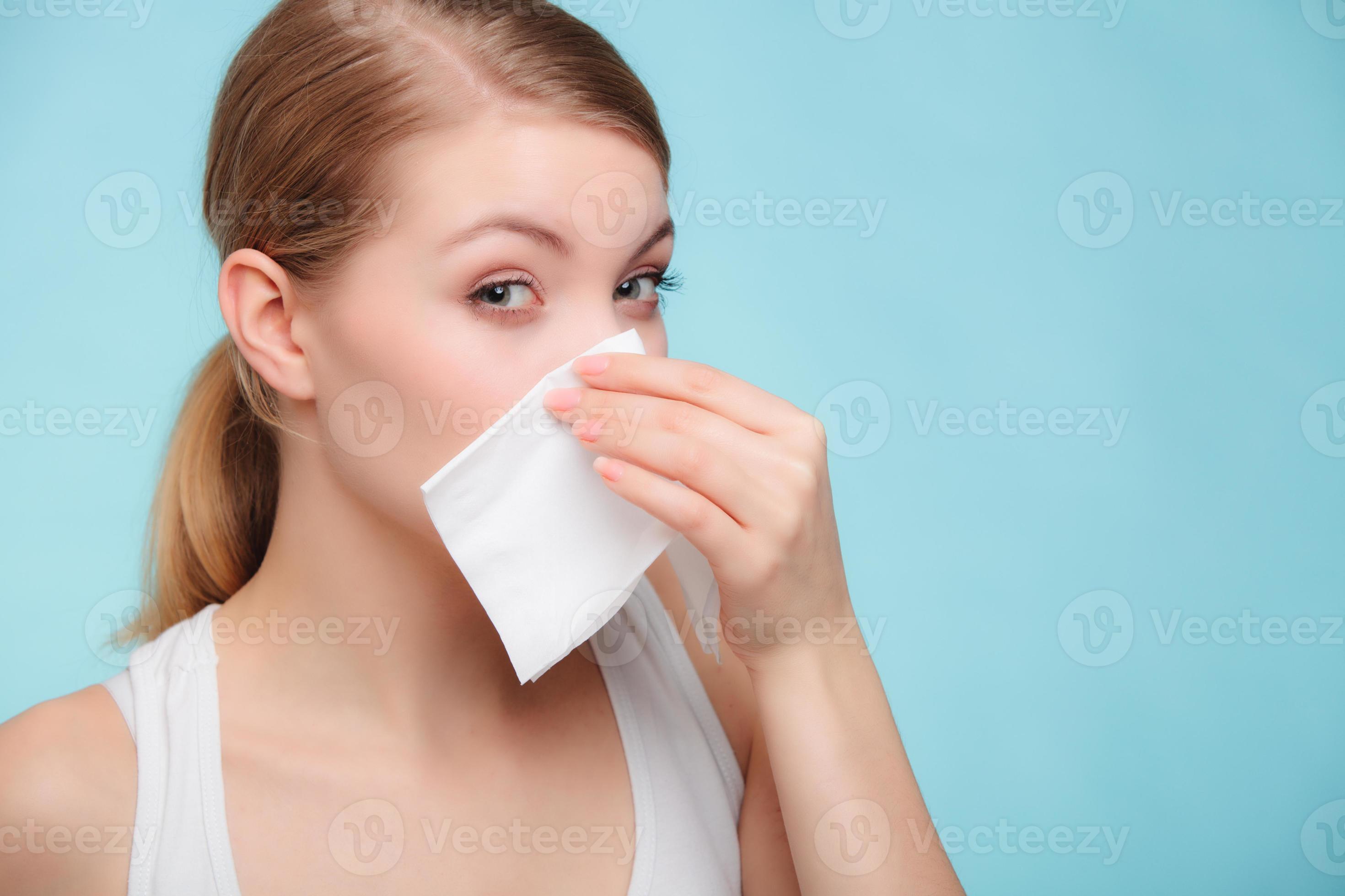 Flu allergy. Sick girl sneezing in tissue. Health