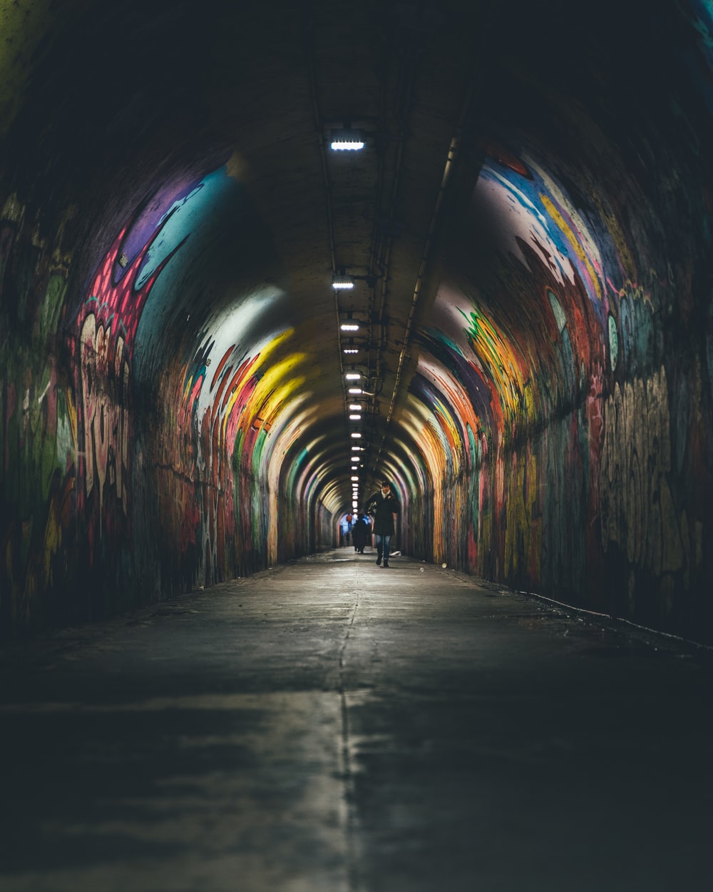 person walking in tunnel photo