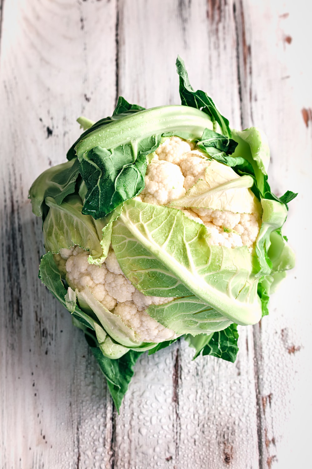 cauliflower on white wooden surface photo