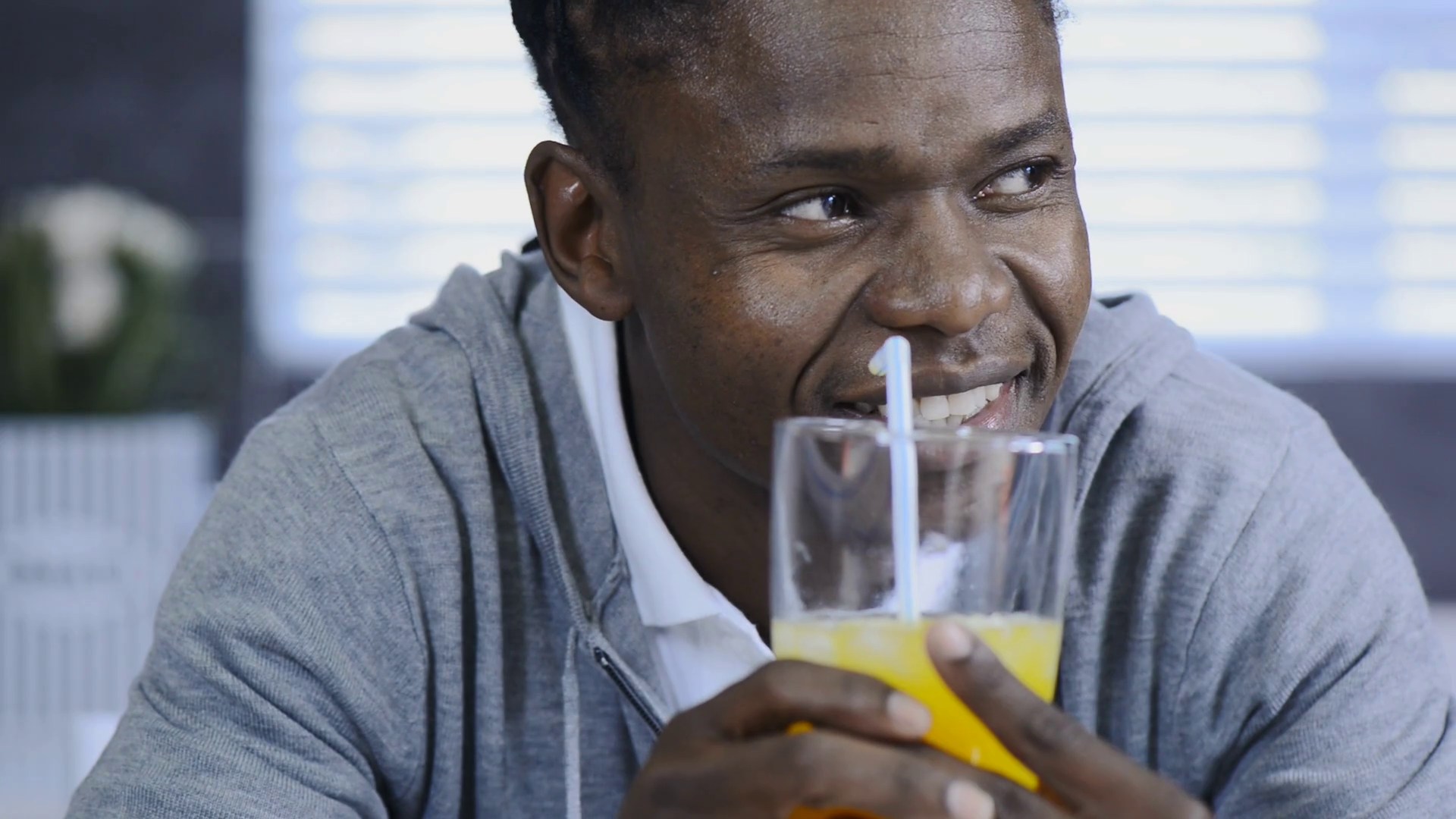 African American man drinking orange juice in modern lifestyle kitchen Stock Video Footage