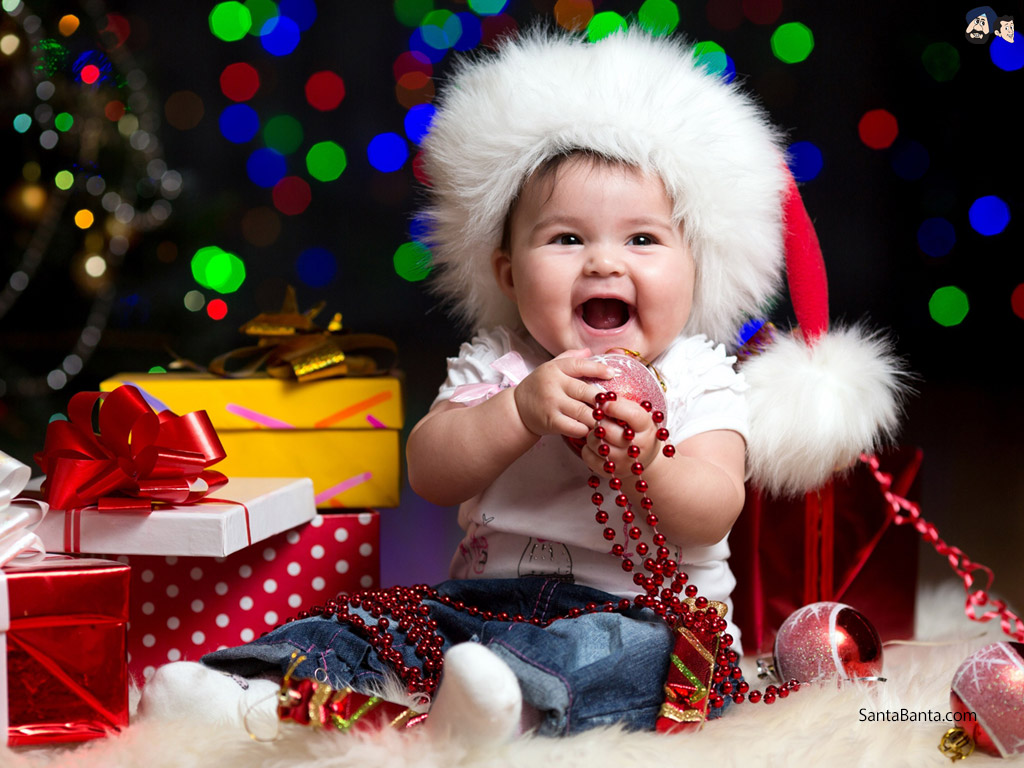 A happy baby playing with Christmas decorations