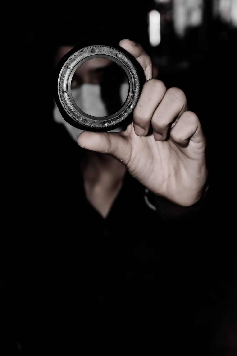person holding black round frame photo