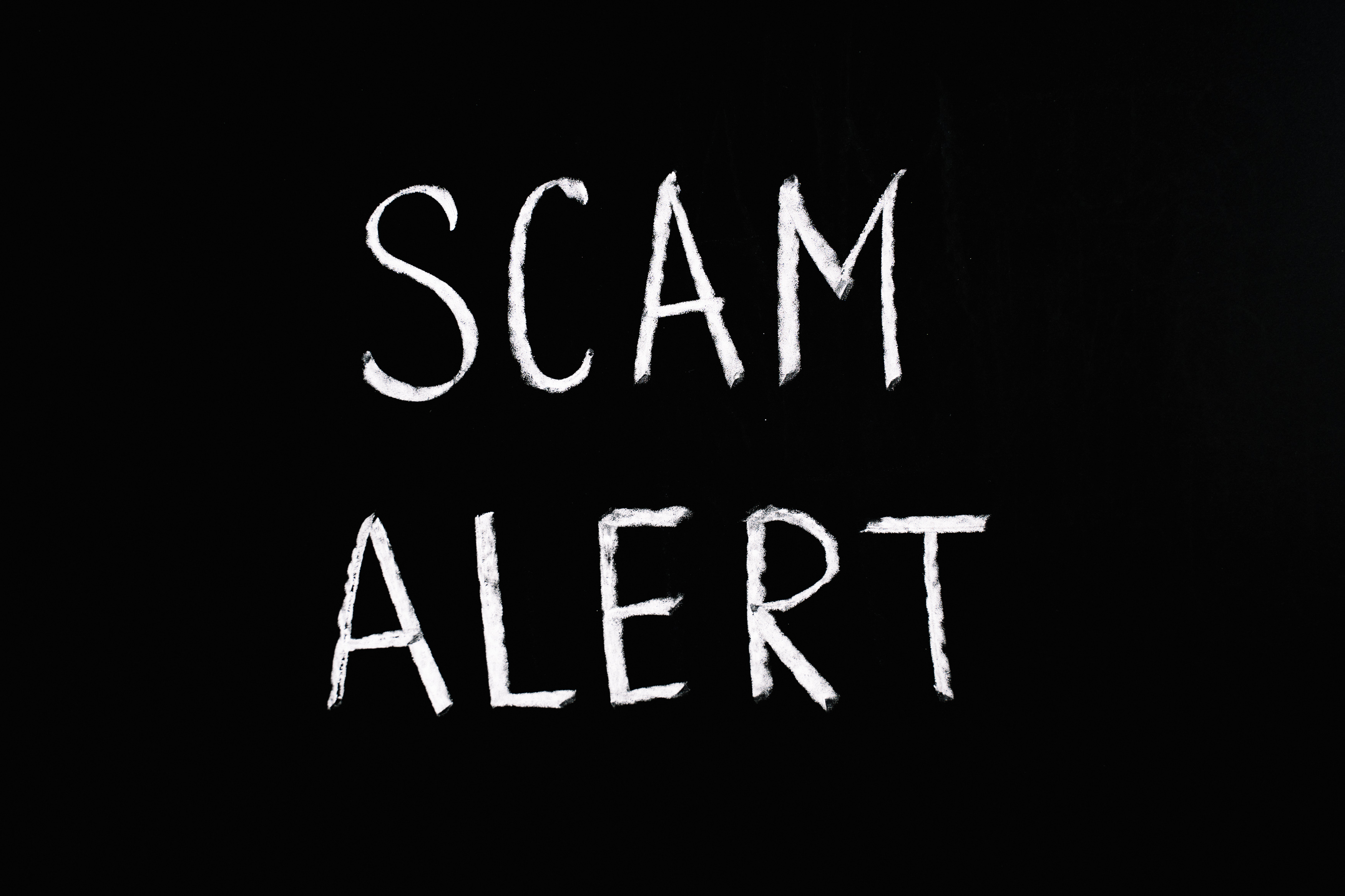 Scam Alert Letting Text on Black Background · Free