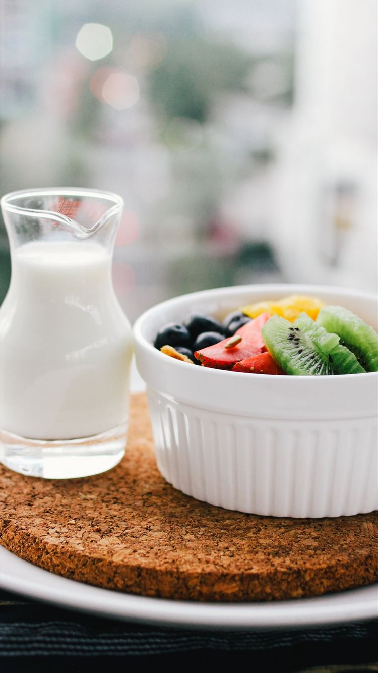 fruit salad inside bowl beside glass of milk on br. iPhone 8 Wallpaper Free Download