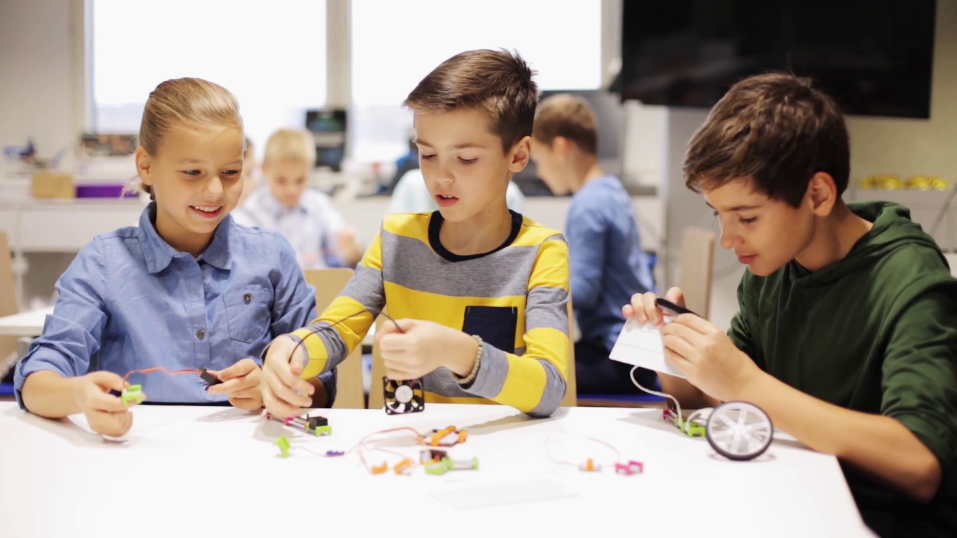 education, children, technology, science and people concept of smiling kids learning to create robots at robotics school lesson Stock Video Footage