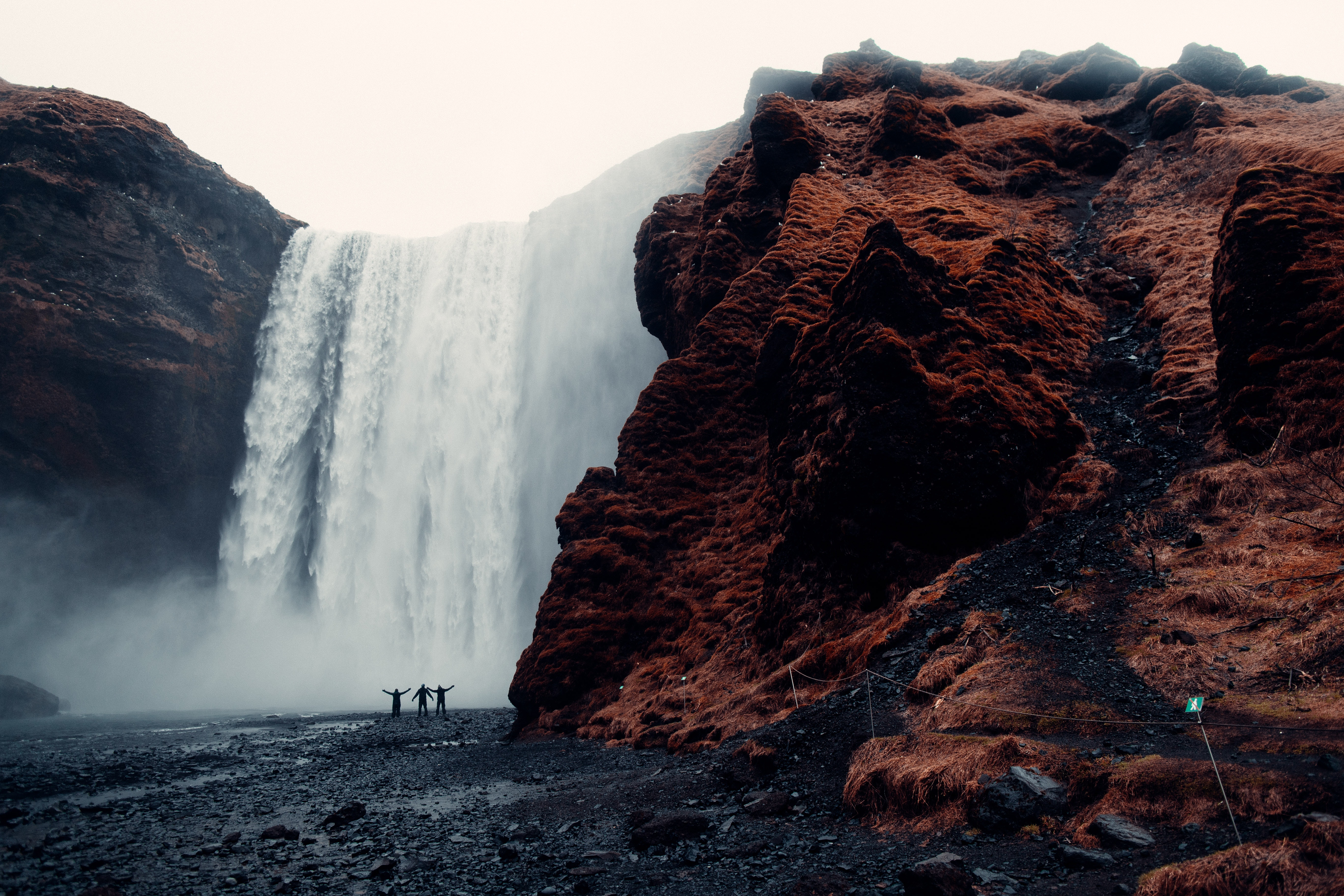 Three Men Standing Near Waterfalls · Free