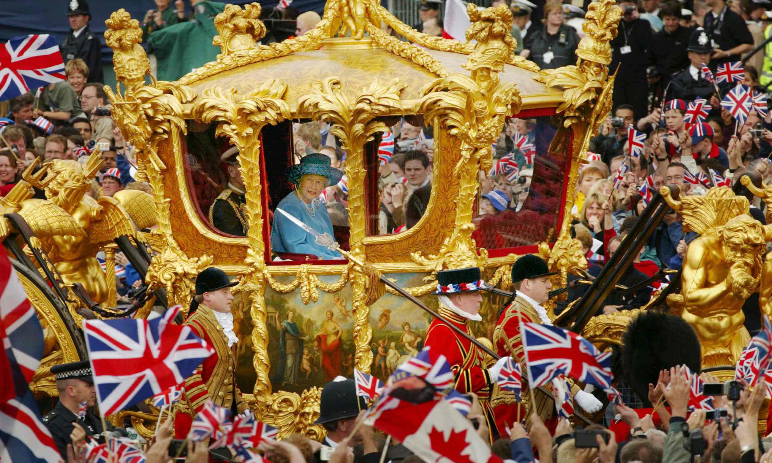 Queen Elizabeth and the Duke of Edinburgh ride in the Golden State Carriage at the head of a parade HD Wallpaper
