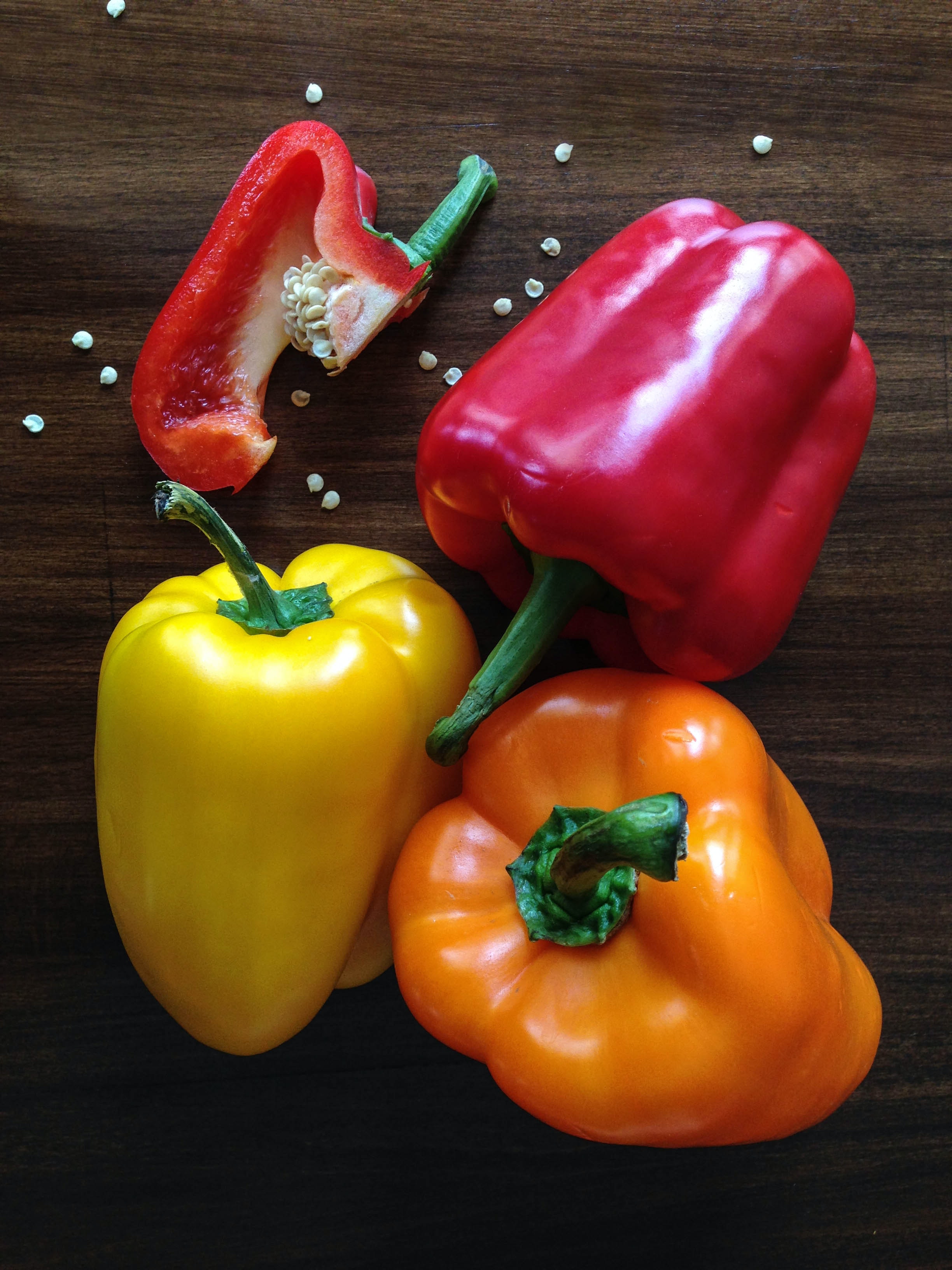 Three Yellow, Red and Orange Bell Peppers on Brown Surface · Free