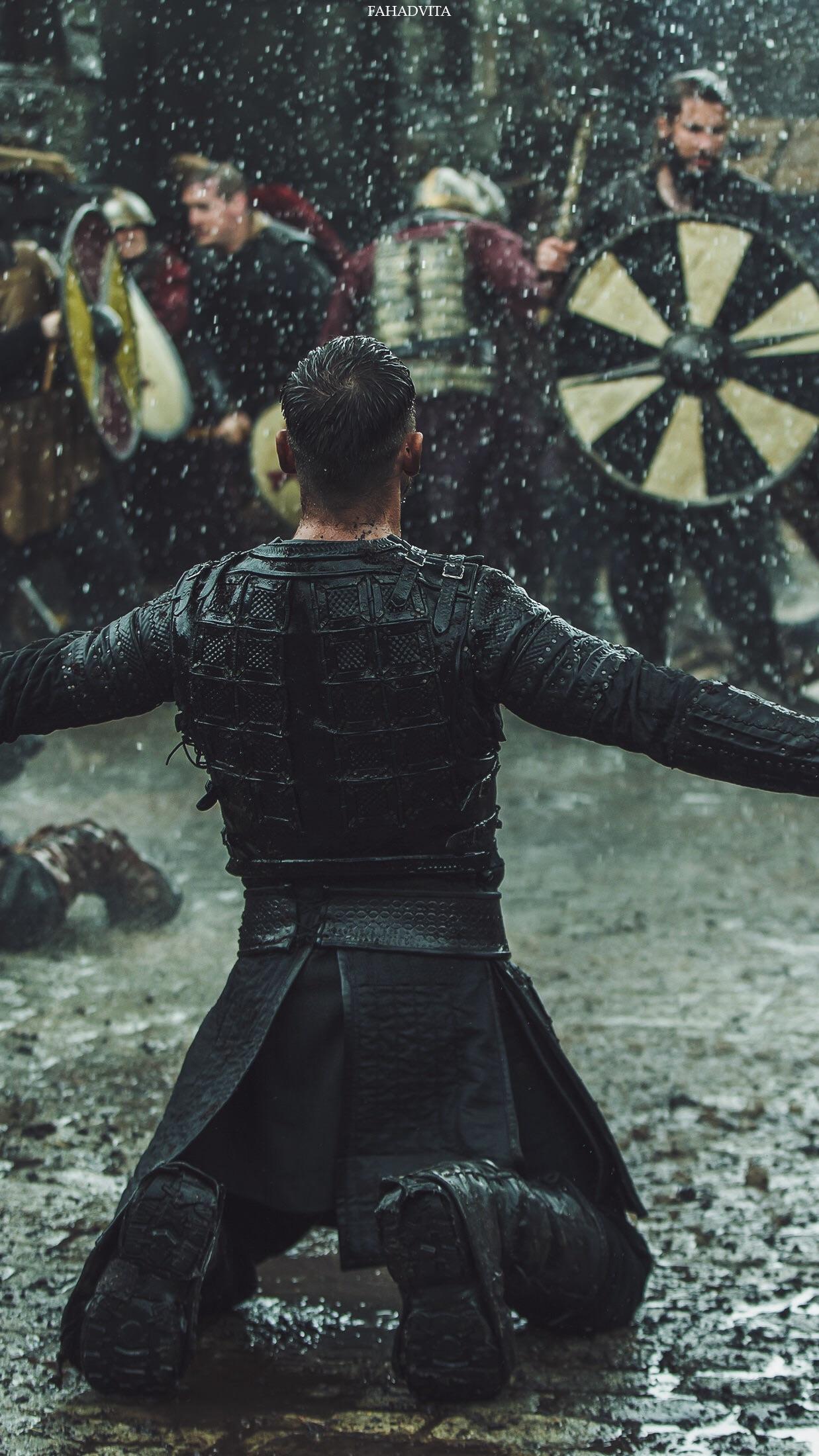 My phones wallpaper, noticed Heahmund is wearing modern black trainers. Leather pants stretch far enough down to cover top of shoes but tread is visible in this shot