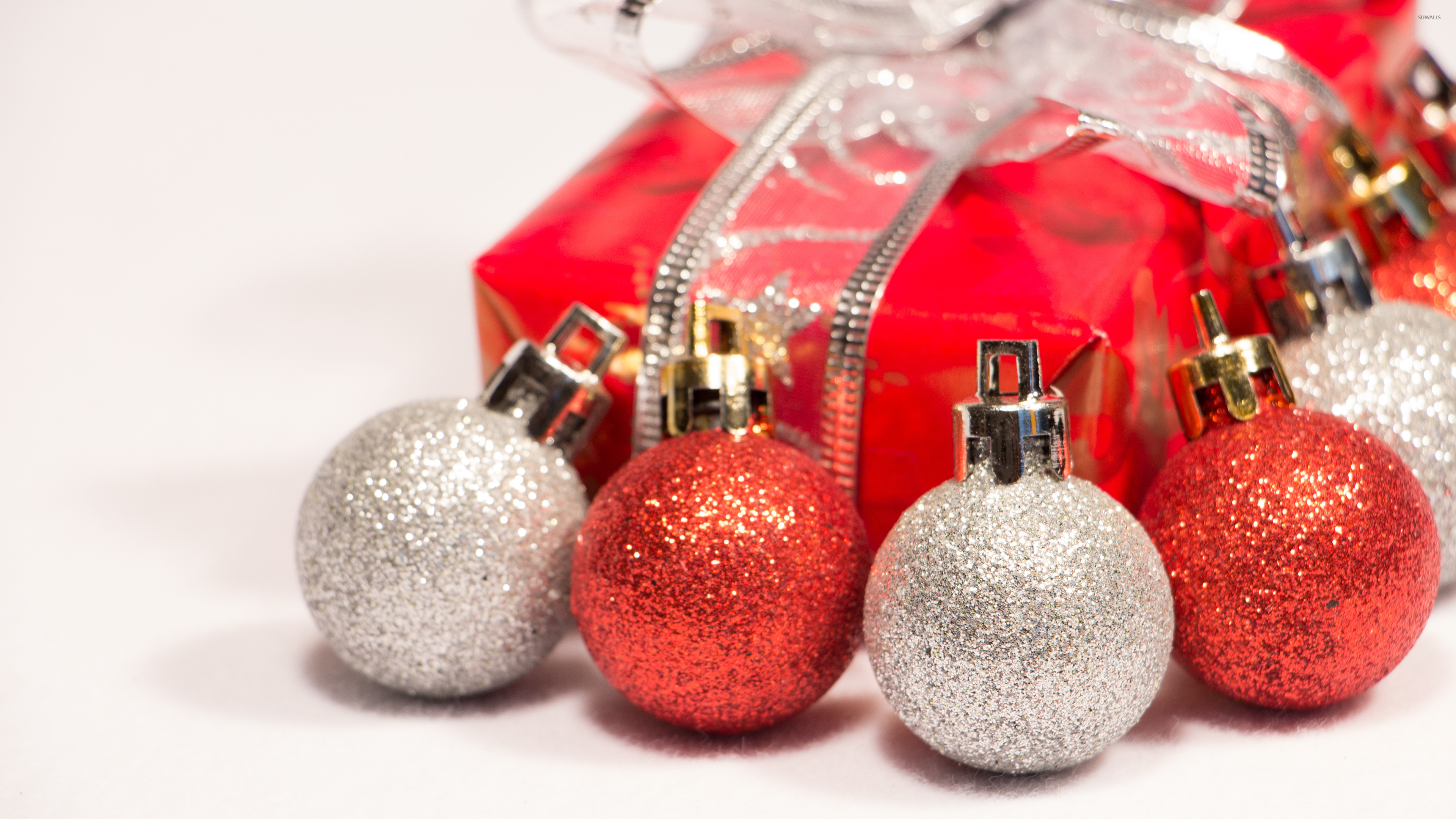 Red and silver baubles with a Christmas present wallpaper wallpaper