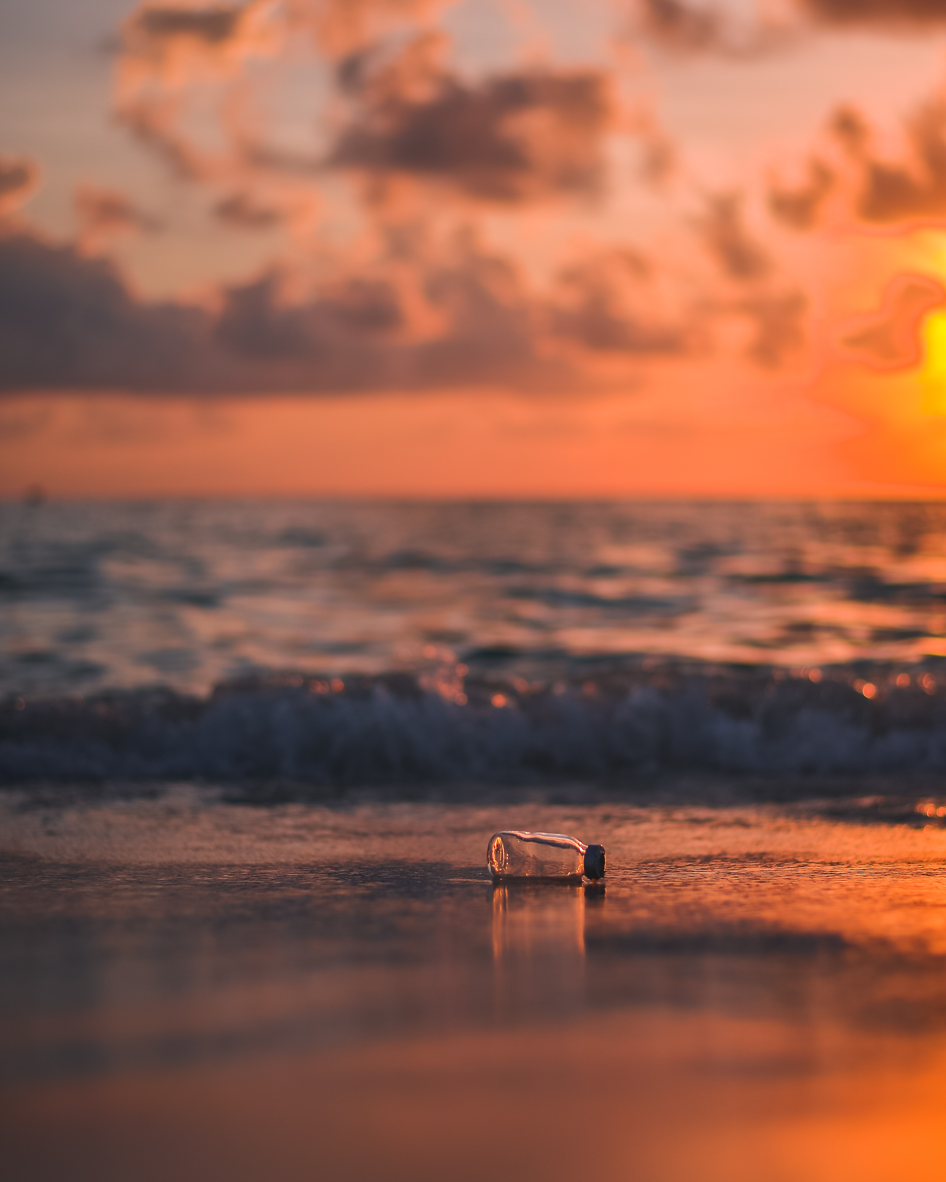 Download wallpaper 3131x3914 bottle, glass, sea, sunset, shore, blur HD background