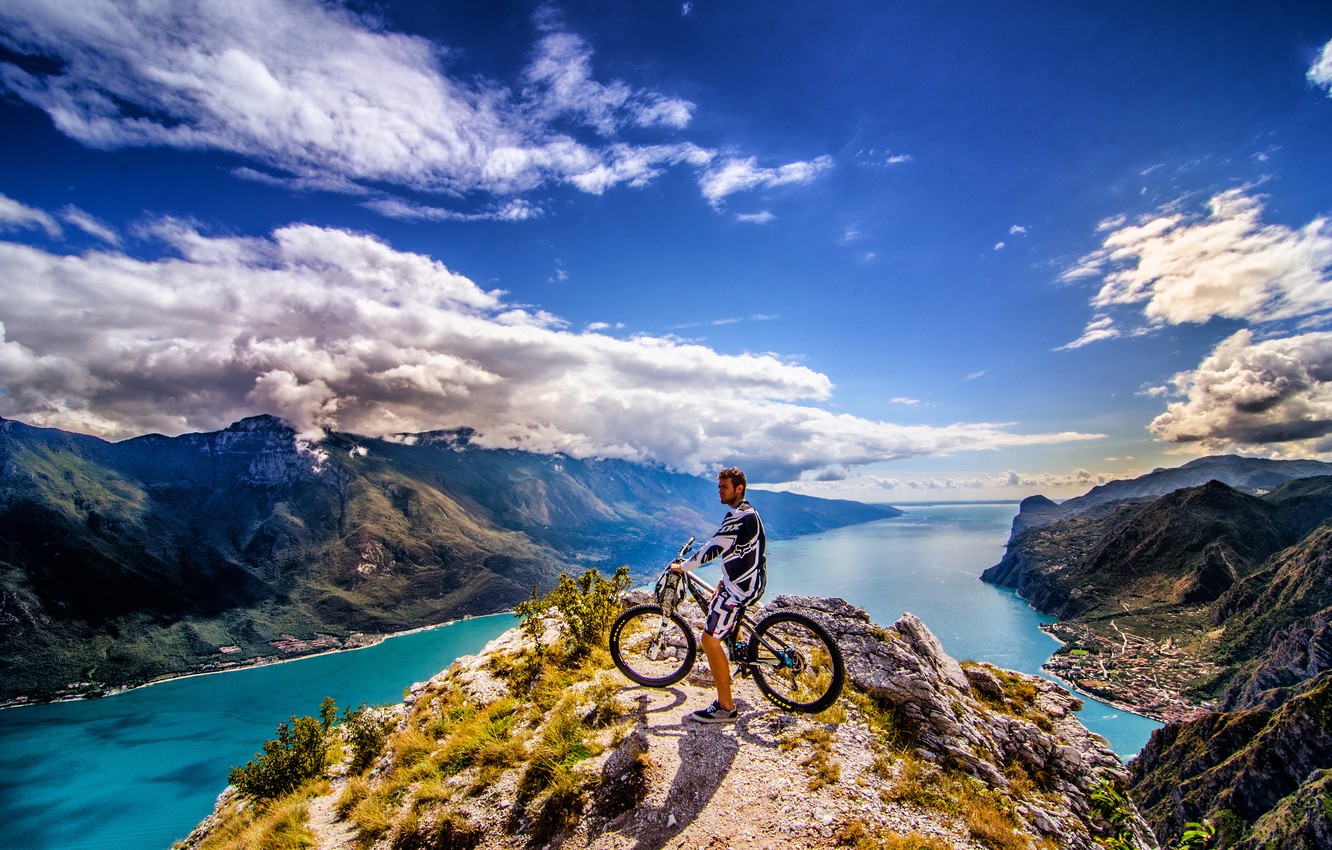 Wallpaper the sky, clouds, mountains, the city, rider, peak, solar, mountain bike, the fjord, extreme sports image for desktop, section спорт