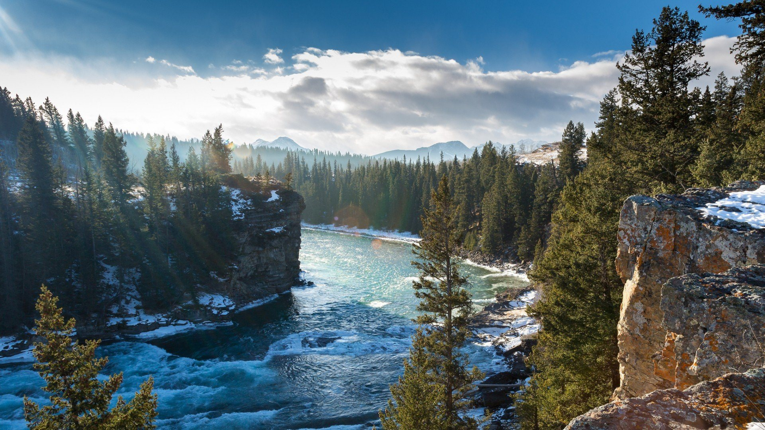 Download 2560x1440 river, canada, landscape, alberta, nature, cliff, tree, clouds Wallpaper