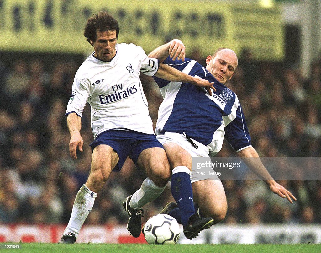 Gianfranco Zola of Chelsea is tackled by Thomas Gravesen of Everton. News Photo