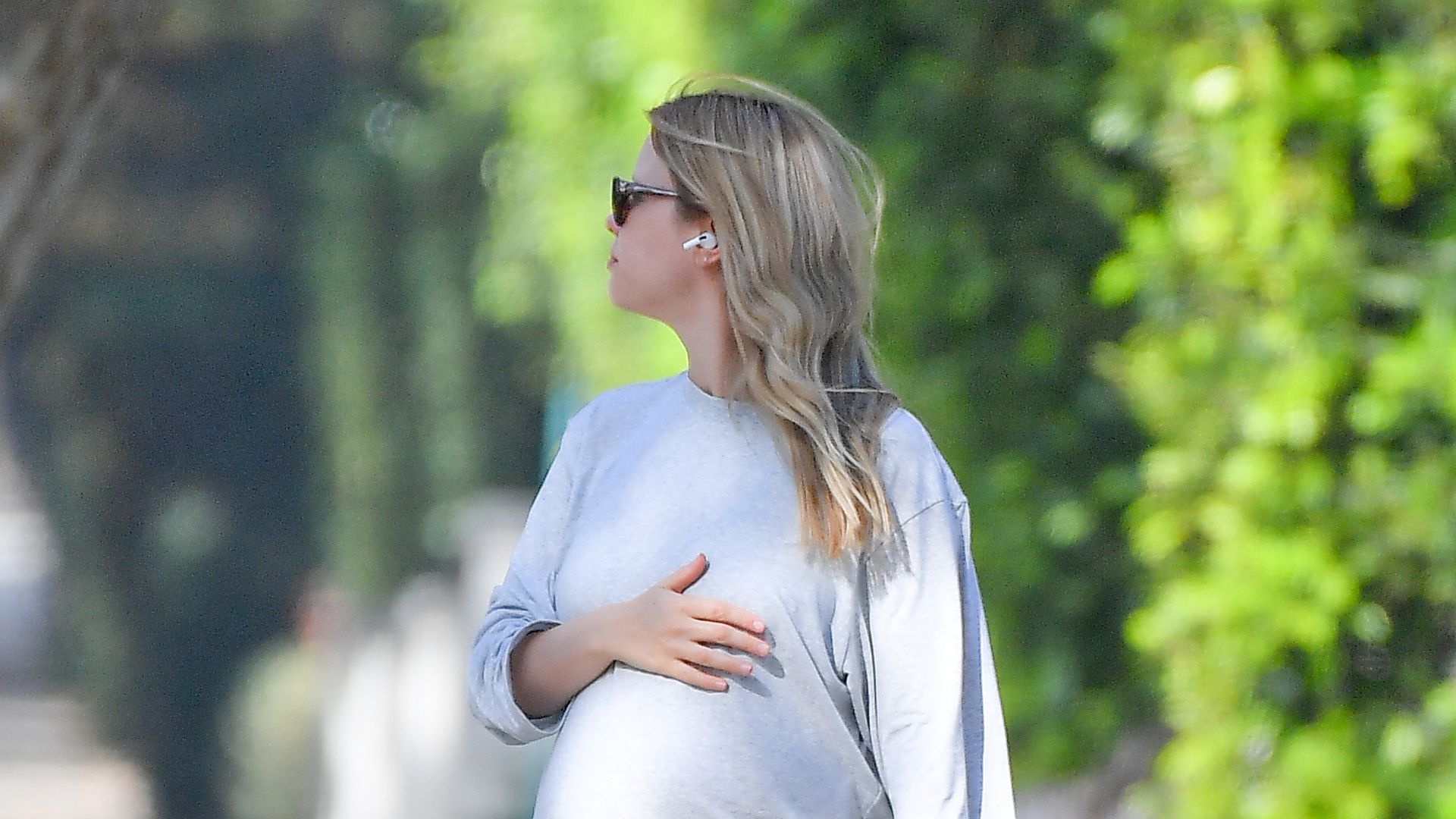Not that much clearer: Mia Goth caresses the baby bump