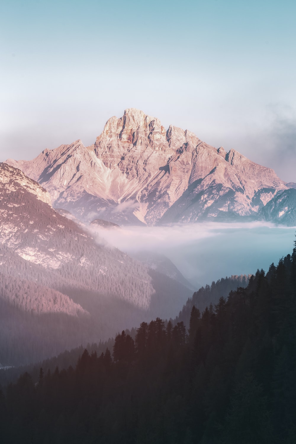 brown mountain and body of water during daytime photo
