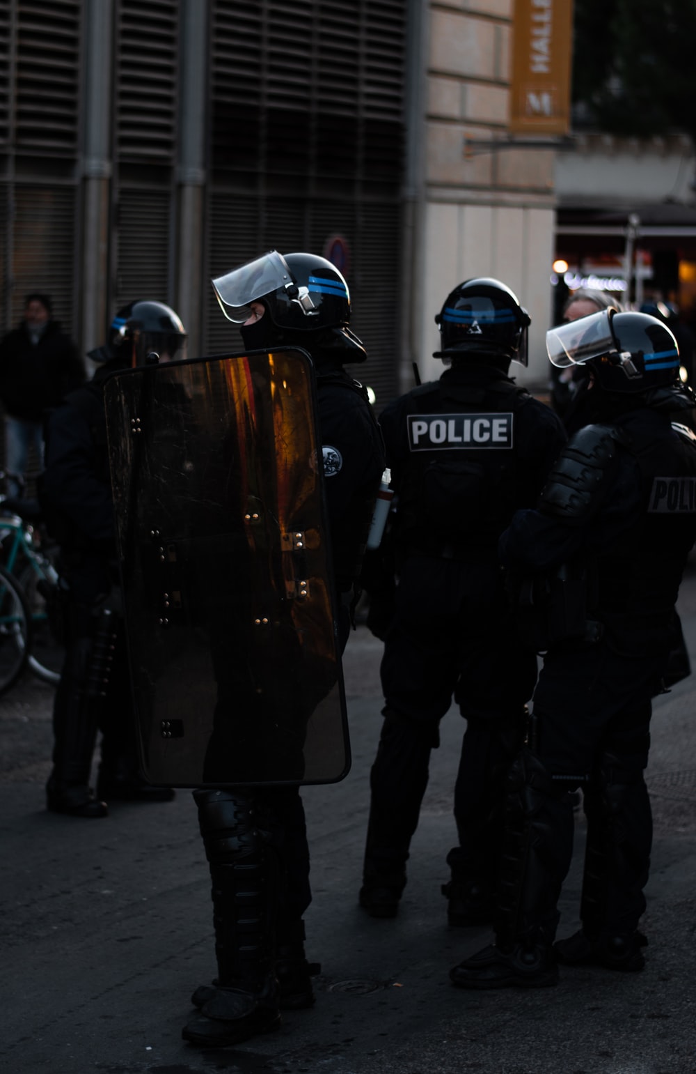 police officer standing and carrying riot shield photo