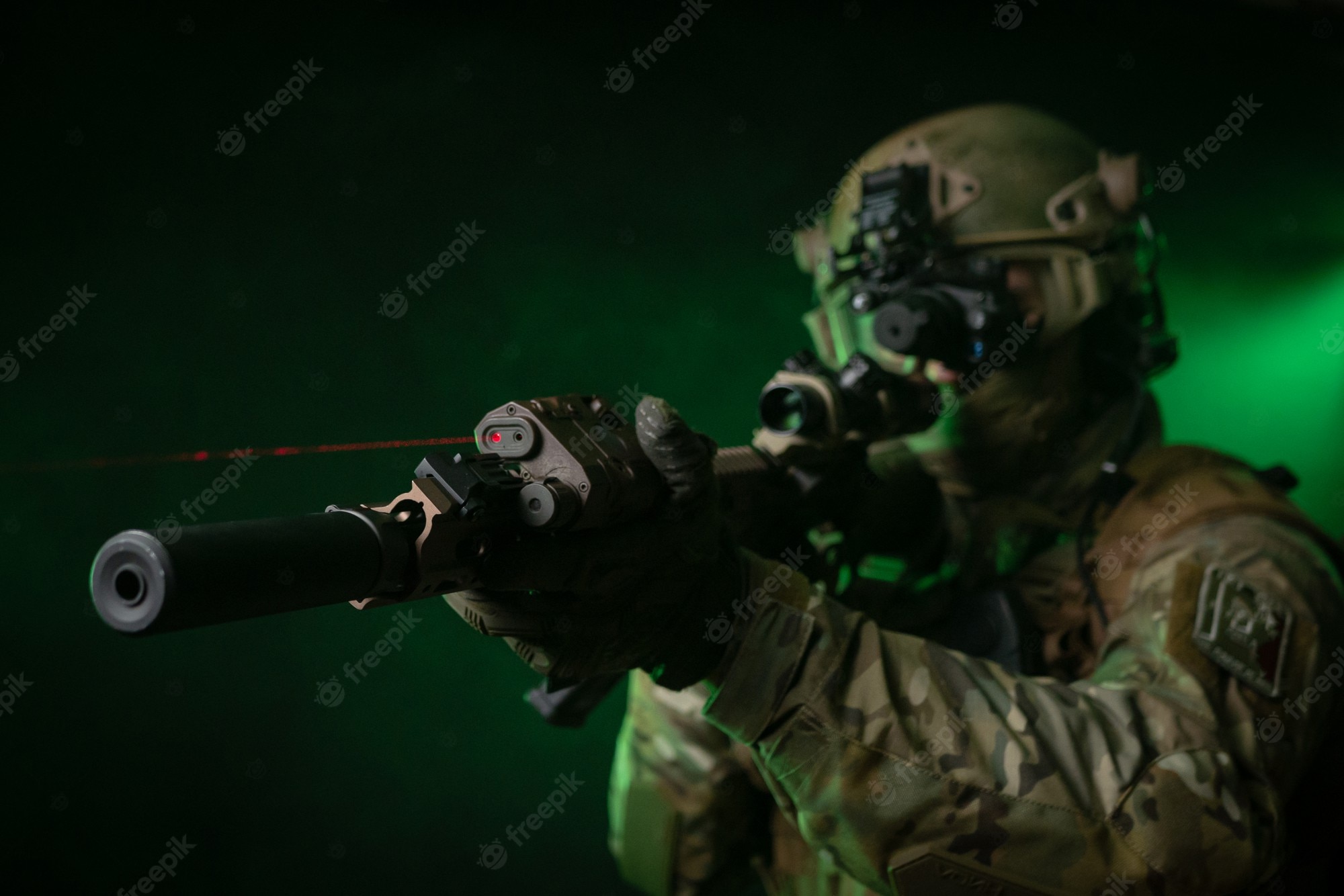 Premium Photo. The soldier in military clothing with a night vision device and on a dark background