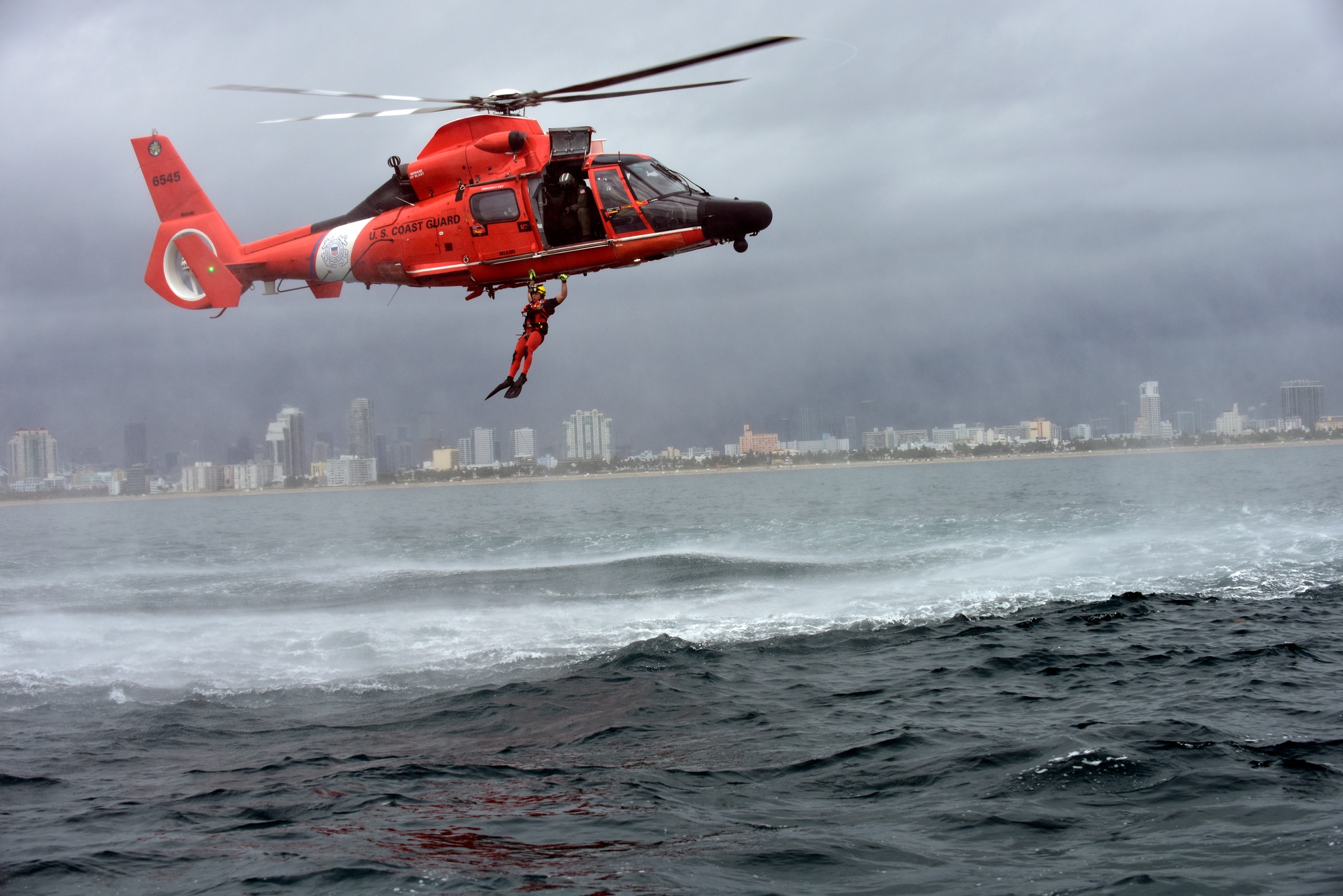 image Guard rescue swimmer conducts free fall deployment from helicopter [Image 7 of 14]