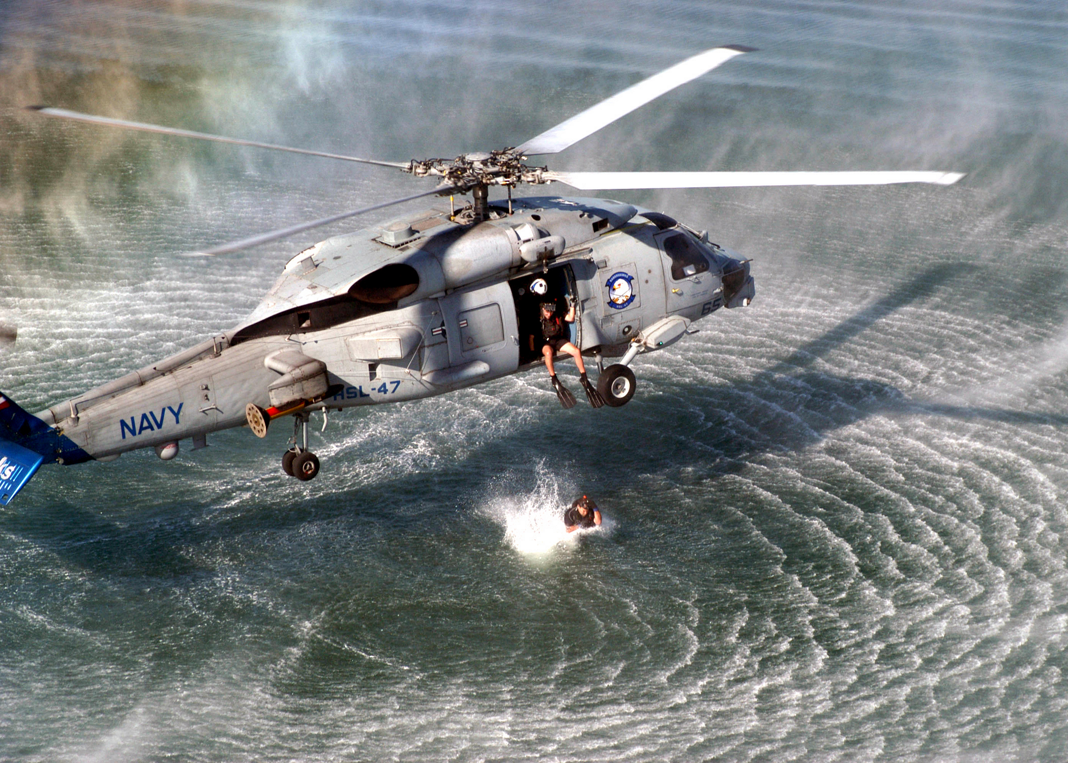US Navy 021004 N 8629M 002 A Search And Rescue (SAR) Swimmer Prepares To Jump From An SH 60B Seahawk