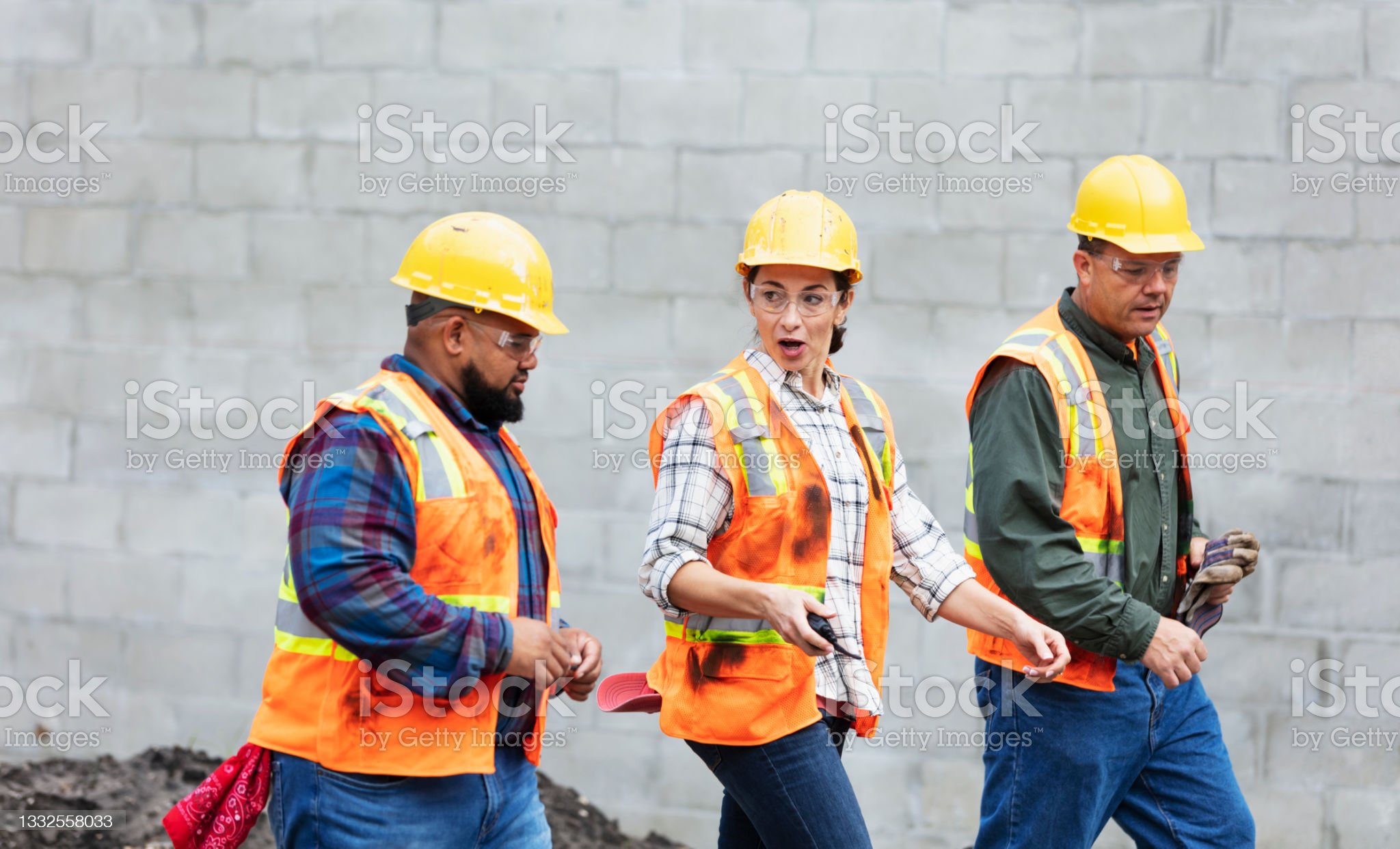 Hispanic woman directs construction workers at job site