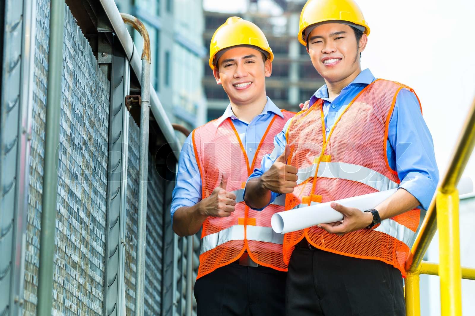 Asian Indonesian construction workers on building site