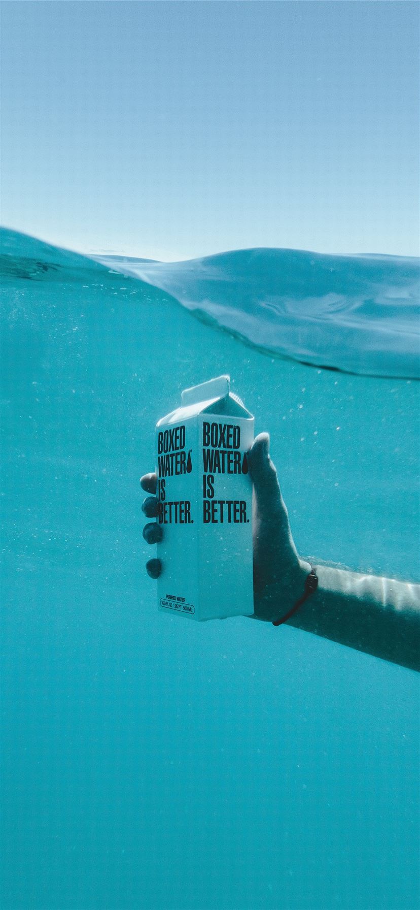 person holding boxed water underwater iPhone 11 Wallpaper Free Download
