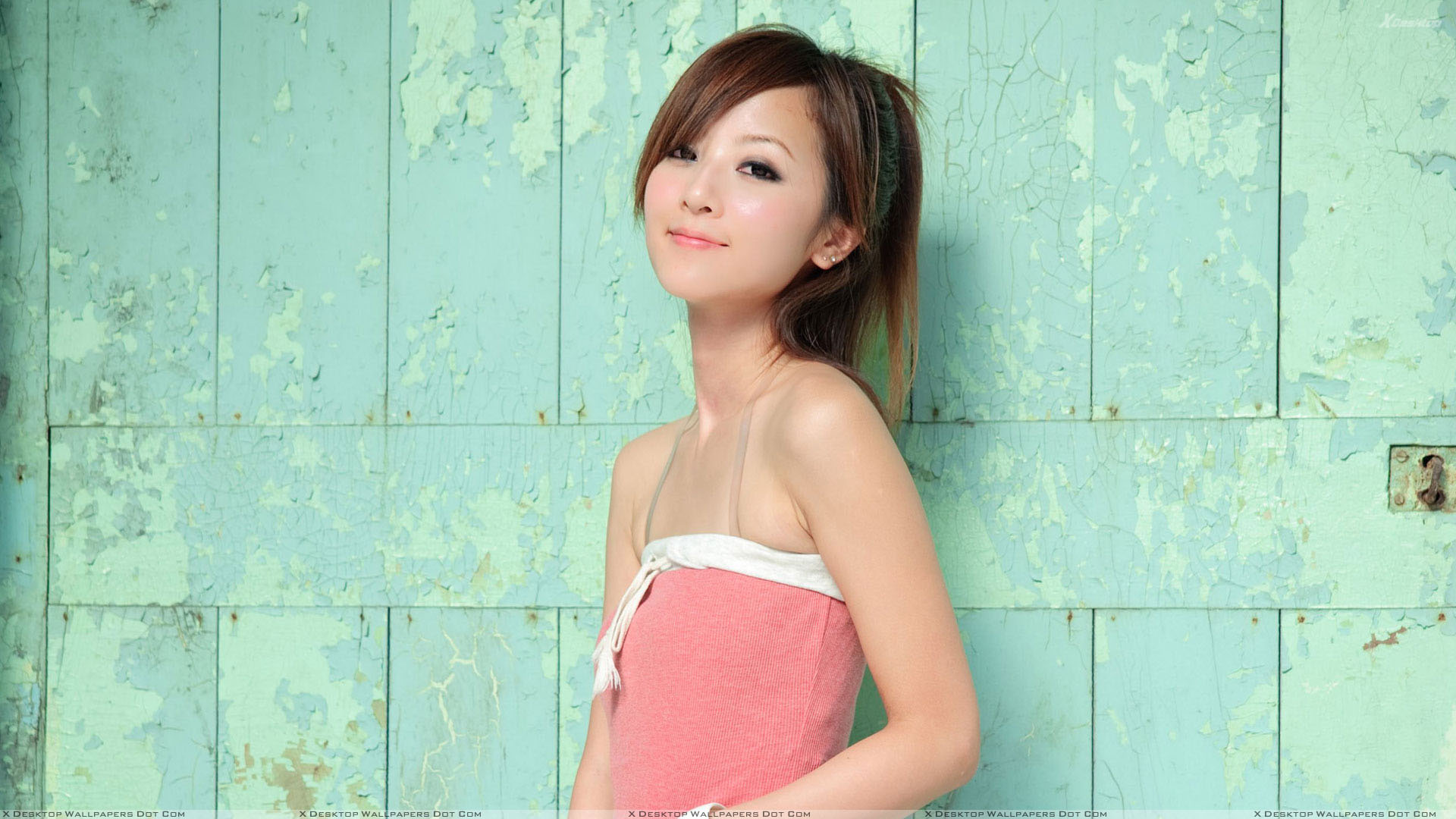 Cute Asian Girl Smiling in Pink Top Side Pose Wallpaper