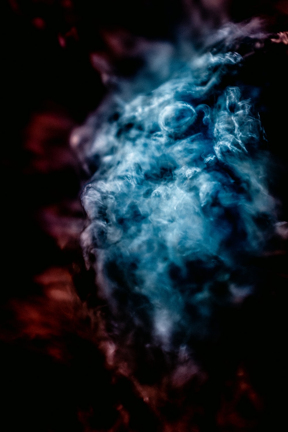 white and blue smoke in close up photography photo