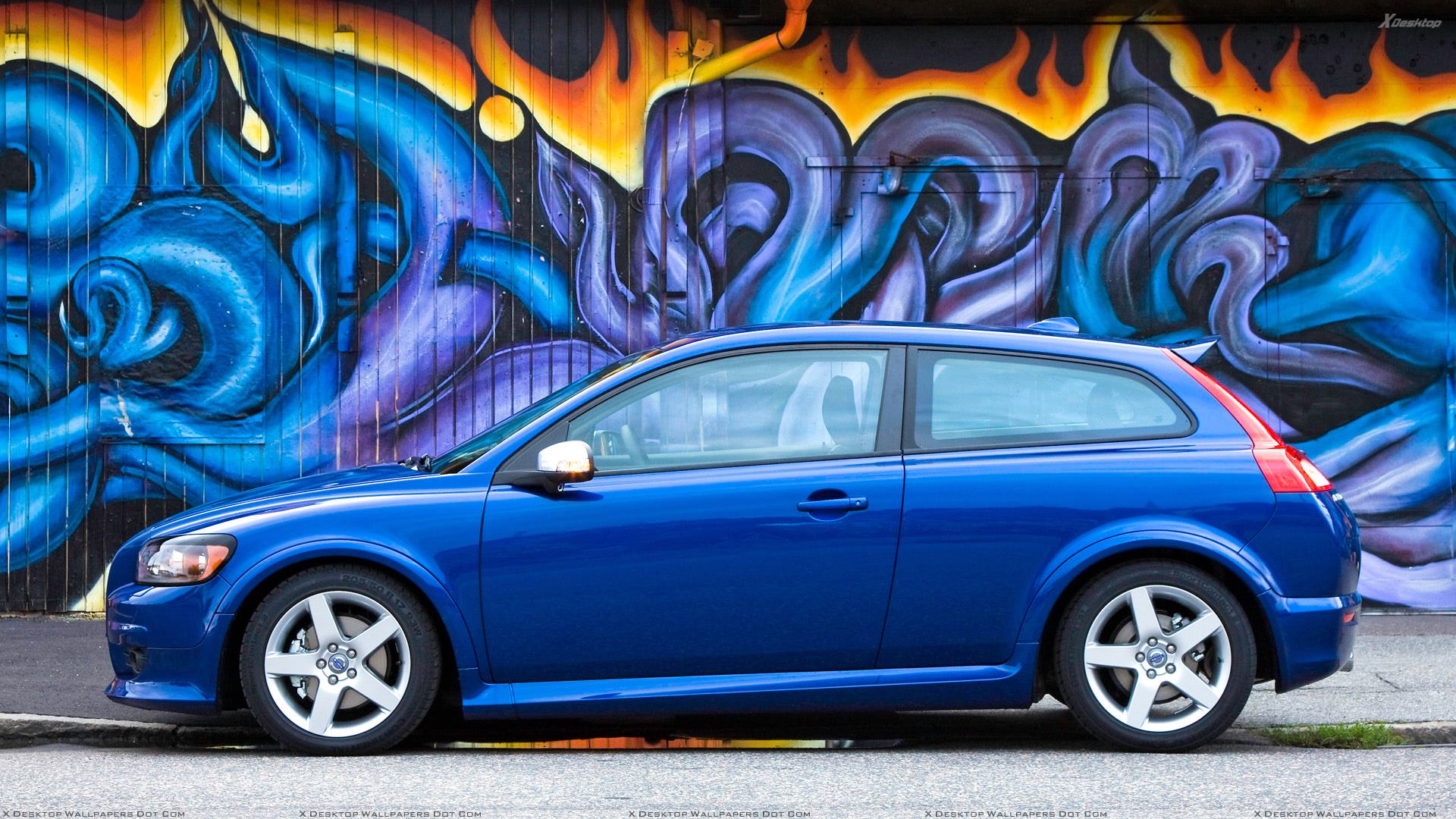Side Pose Of 2010 Volvo C30 In Blue N Painted Background Wallpaper
