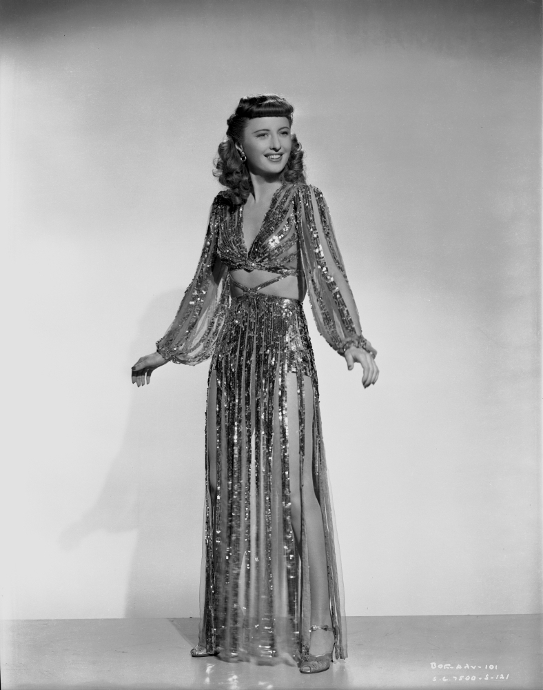 Barbara Stanwyck standing in Dangling Long Dress Classic Portrait Photo Print # VARCEL707611