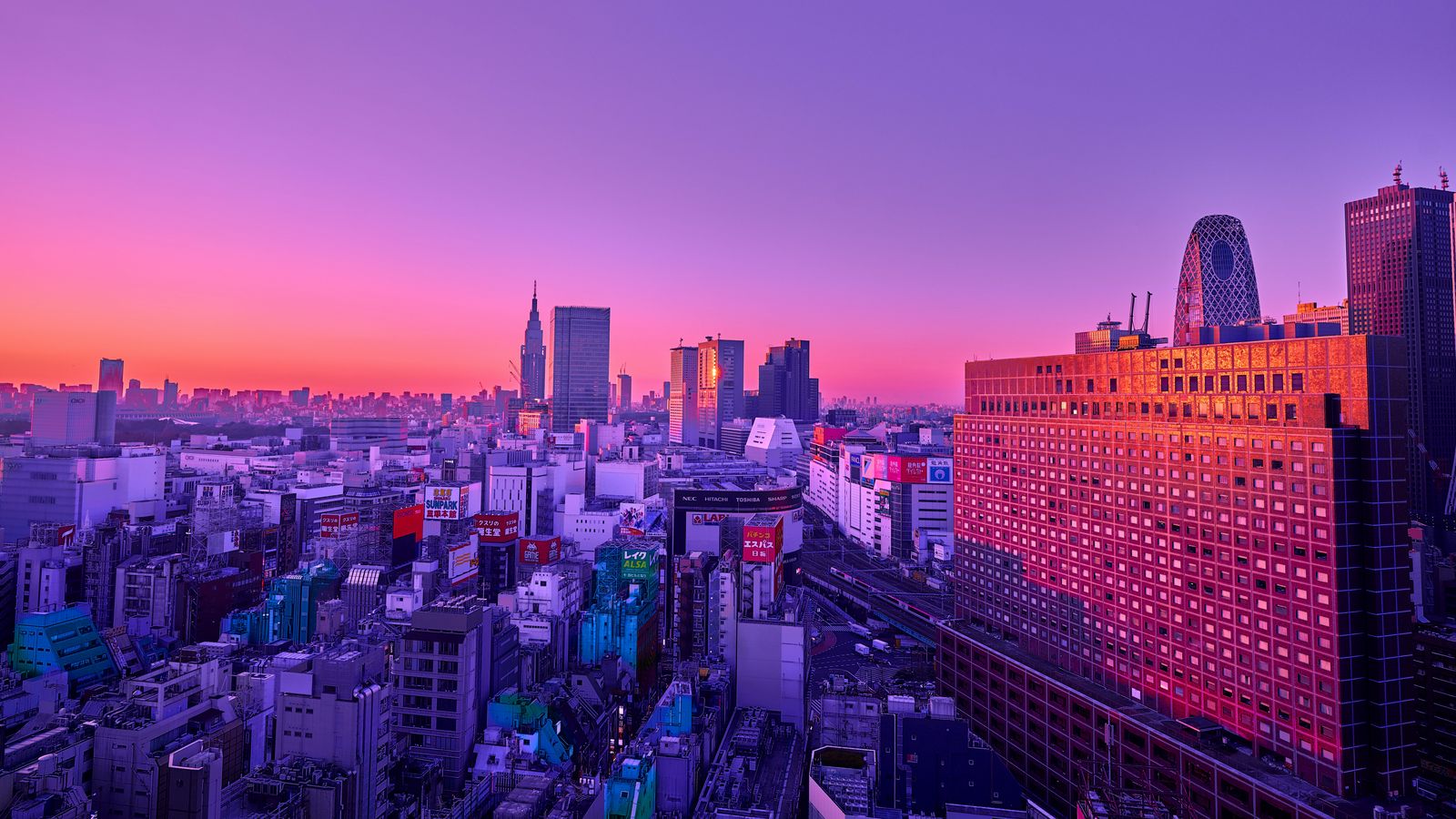 Download wallpaper 1600x900 city, aerial view, buildings, dusk, purple widescreen 16:9 HD background