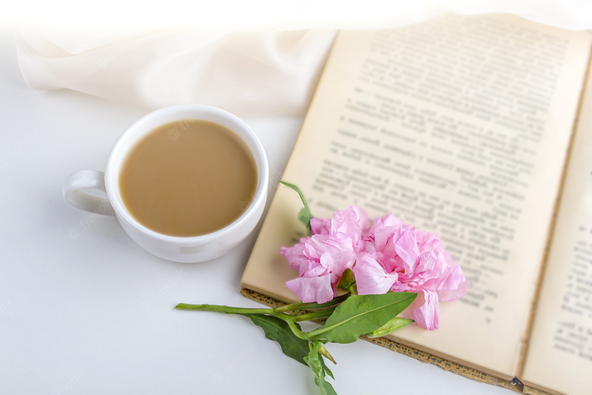 Premium Photo. Romantic vintage still life with pink flowers, old book, cup of tea or coffee in spring, summer day in garden