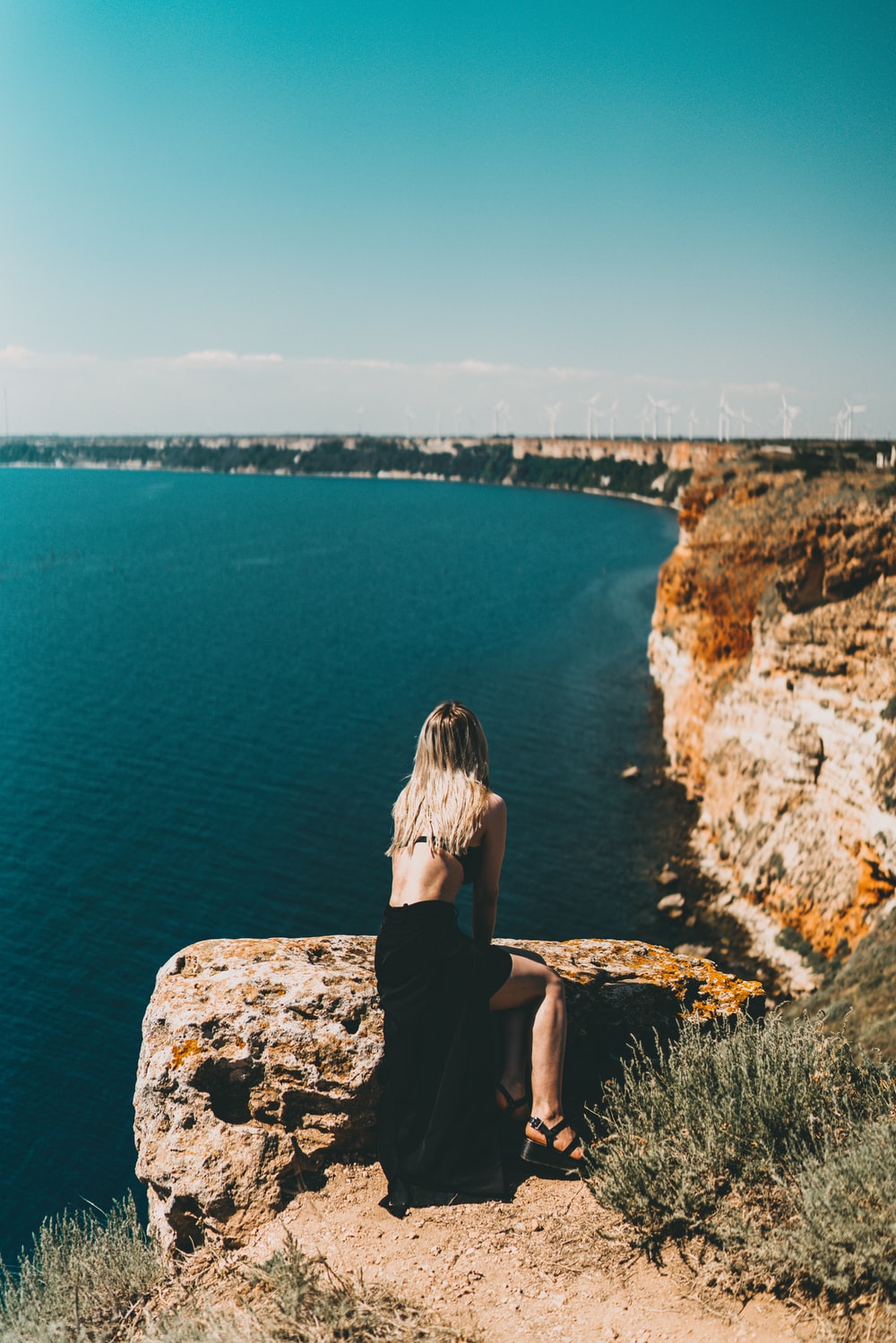 brown rocky mountain beside blue sea during daytime photo
