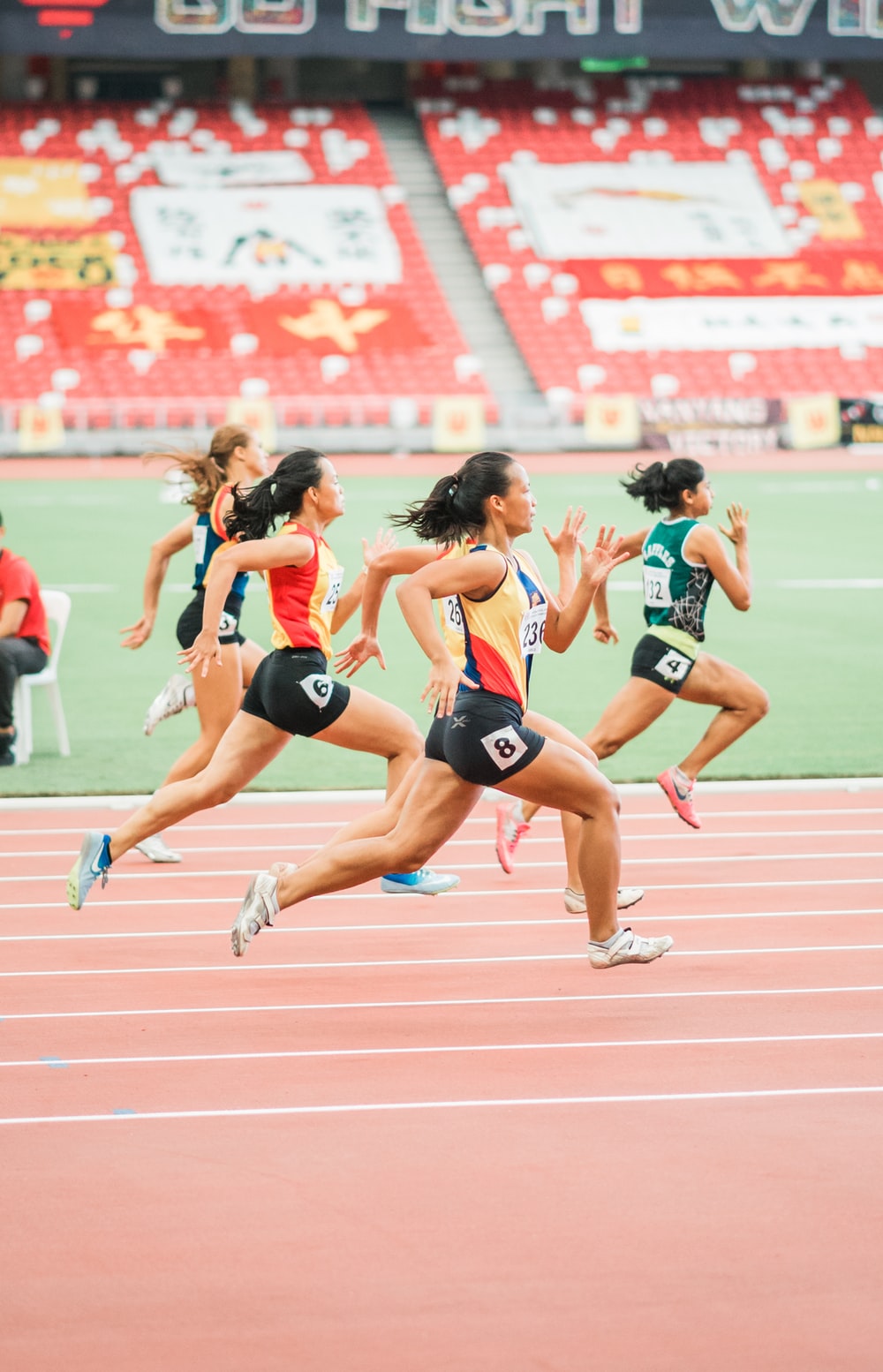 women running on track field photo