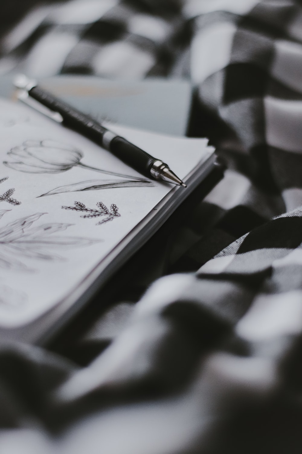black pen on white and black textile photo