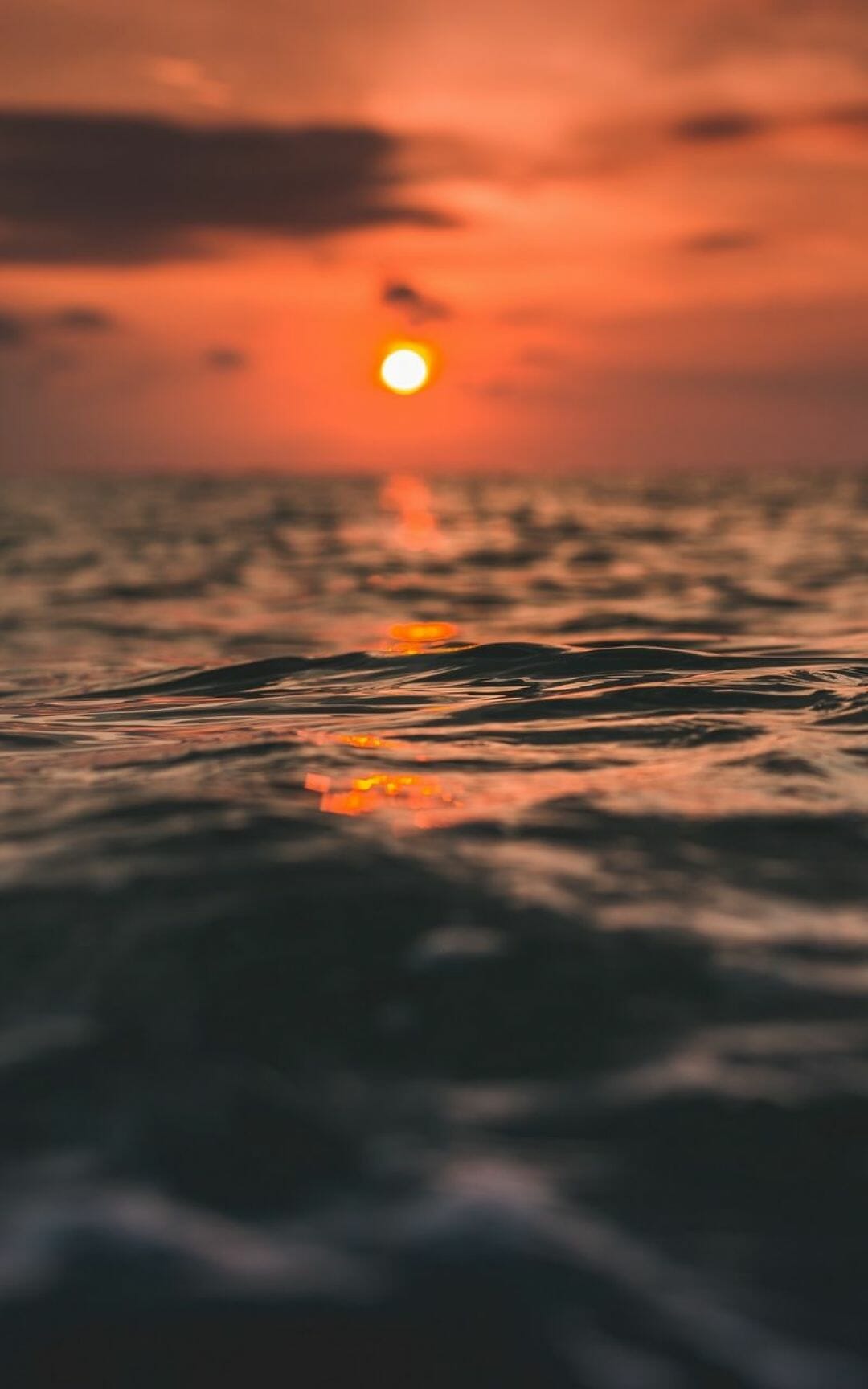 Download wallpaper 800x1280 waves, sun, sunset, water