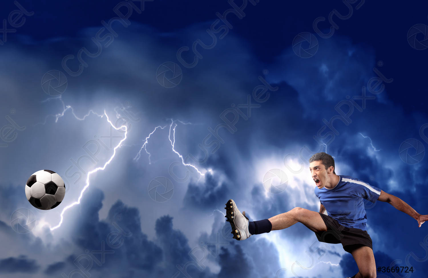 Soccer or football player kicking ball against a stormy sky
