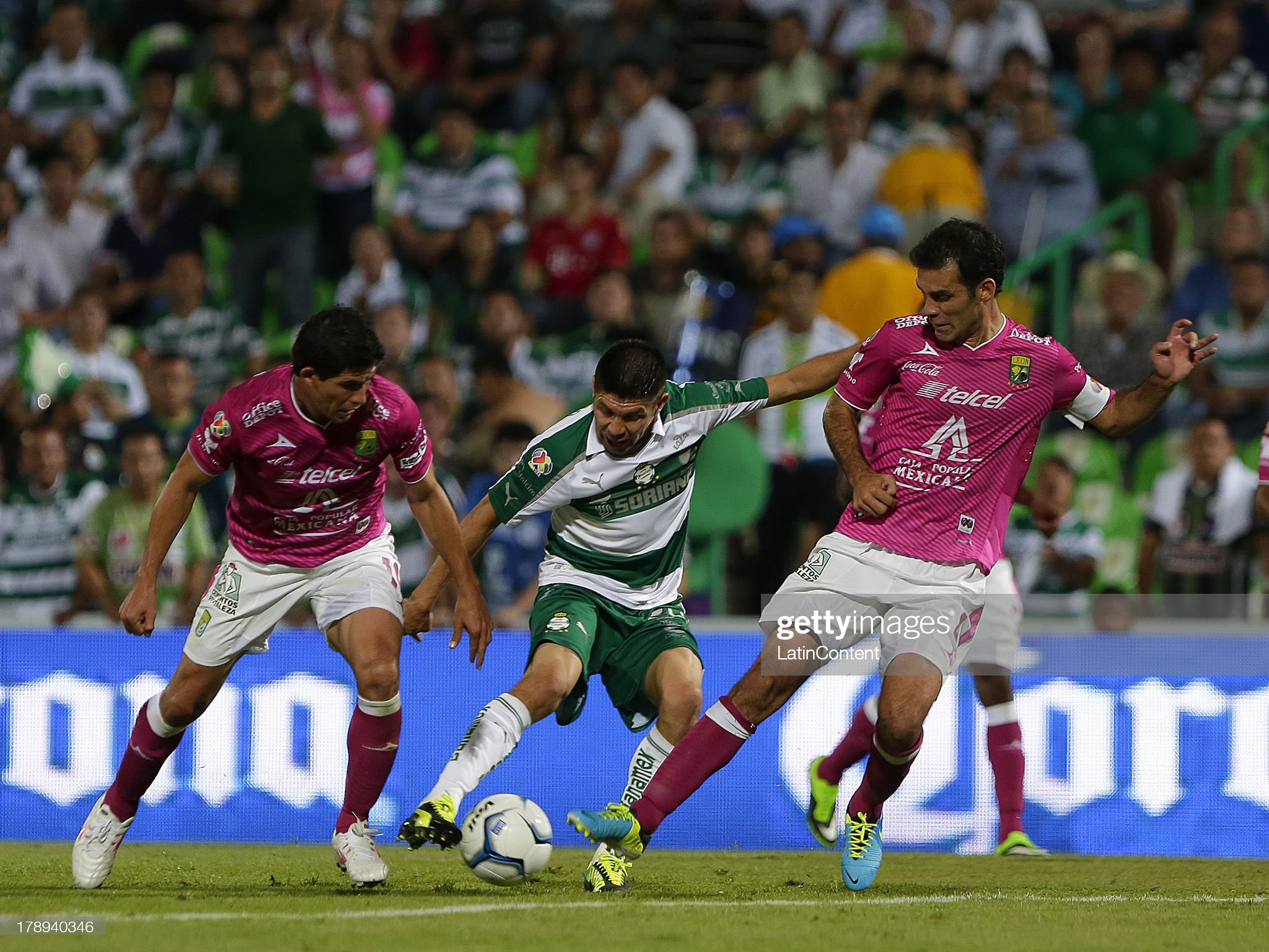 Oribe Peralta of Santos struggles for the ball with Rafael Marquez. News Photo