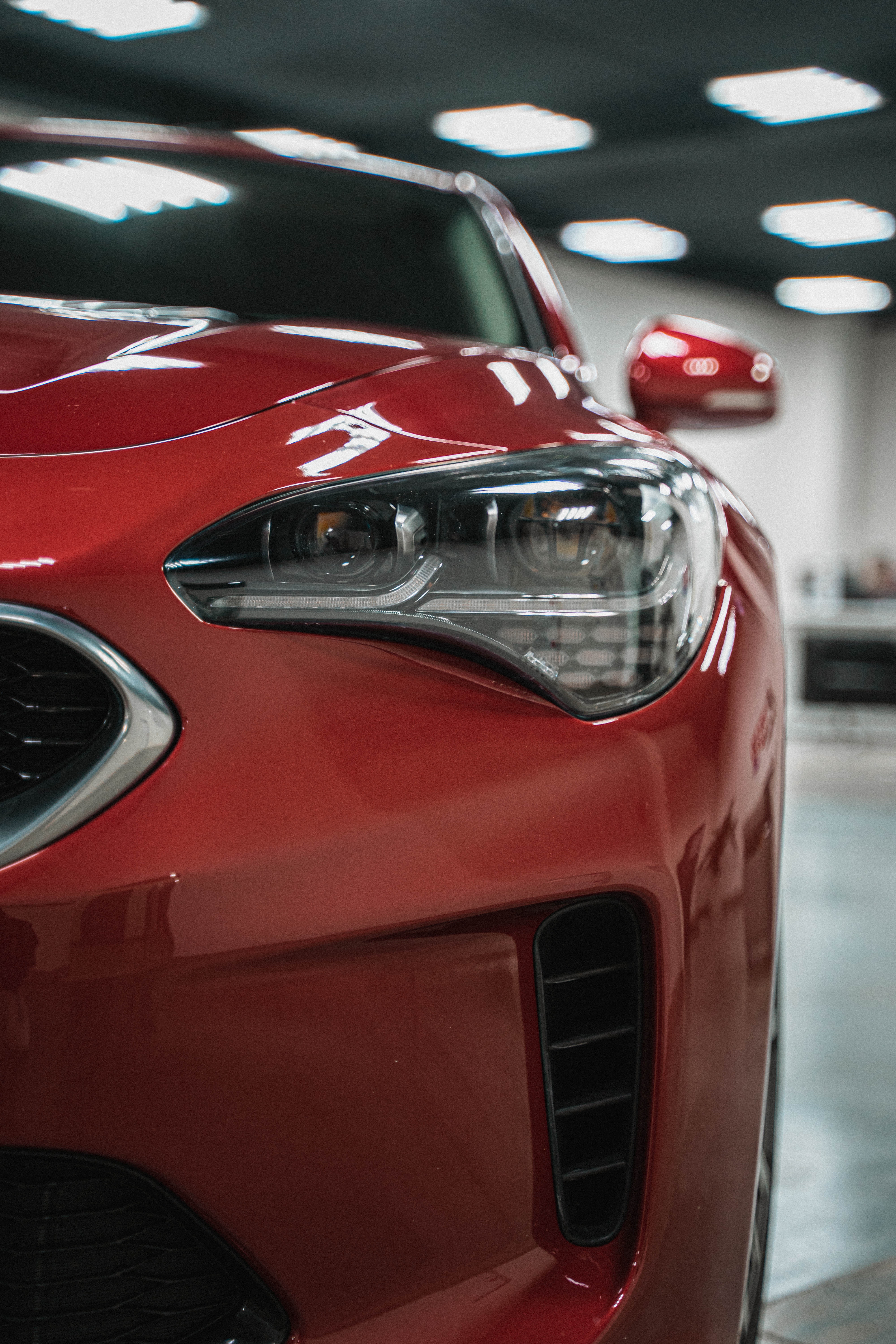 Close Up Photograph Of A Red Car's Headlight · Free