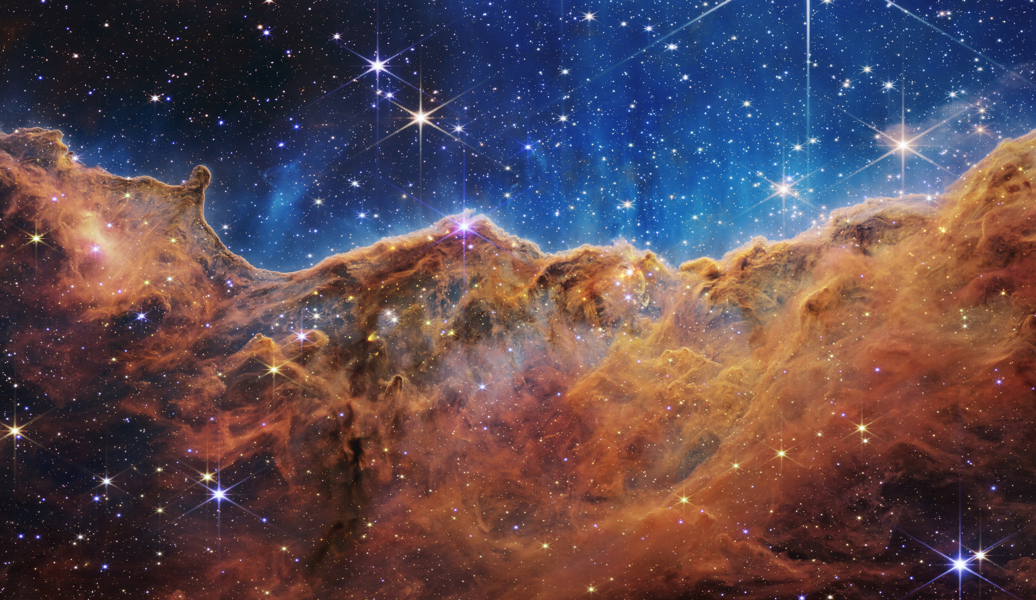 NASA's Webb Reveals Cosmic Cliffs, Glittering Landscape of Star Birth