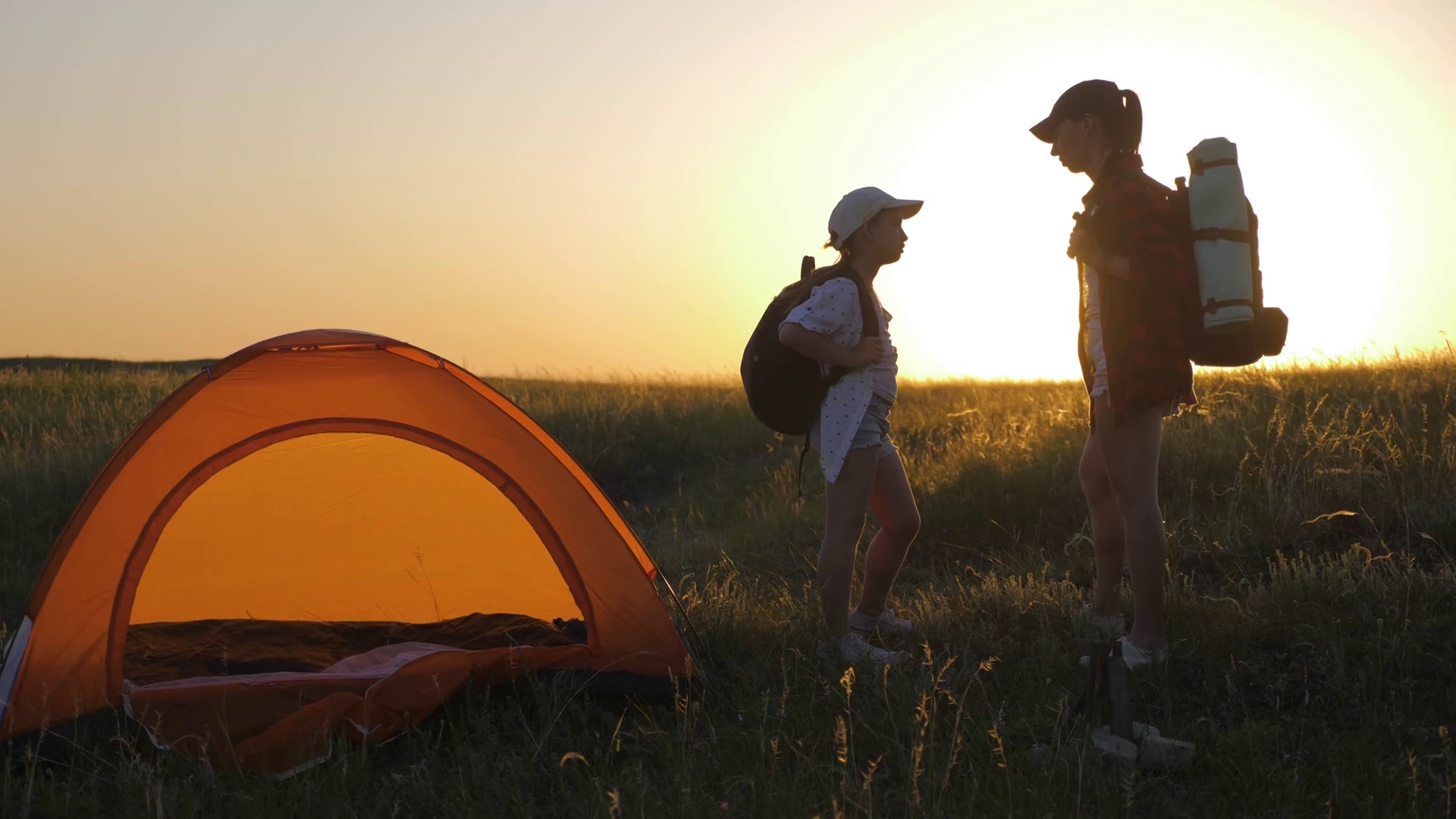 Modern Tourist Family Camping In Mountains At Sunset. Silhouette Mother And Daughter Resting In A Tent Camp. Tourism And Traveling Concept. Stock Video Footage 00:23 SBV 338590451