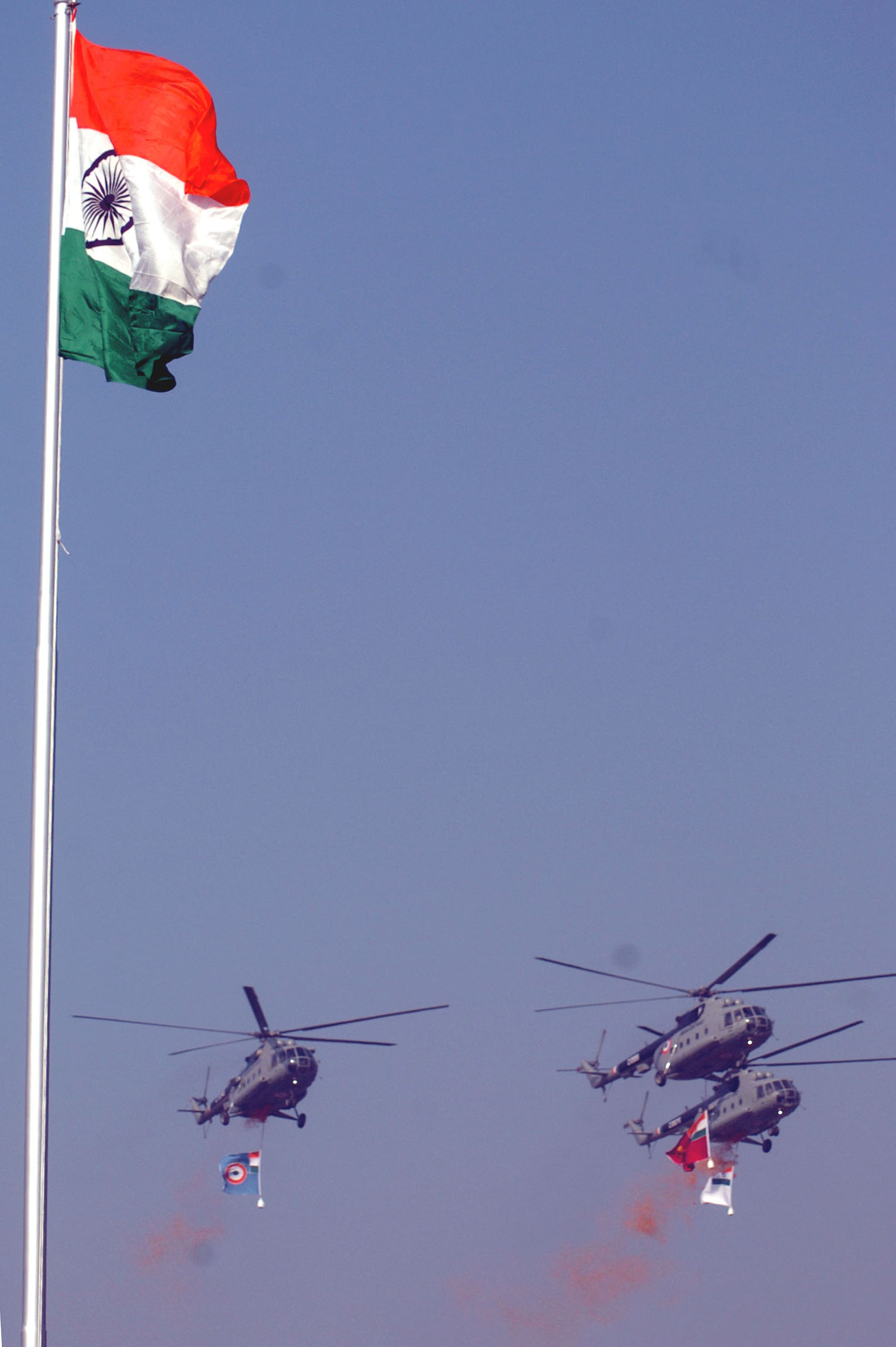 IAF helicopters showering rose petals from the sky while Indian tricolor flutters in the skyline of India Gate on the occasion of Republic Day Parade- in New Delhi on January