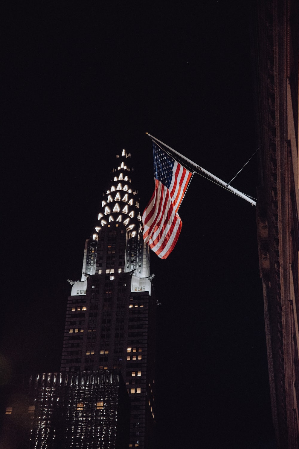 us a flag on top of building during night time photo
