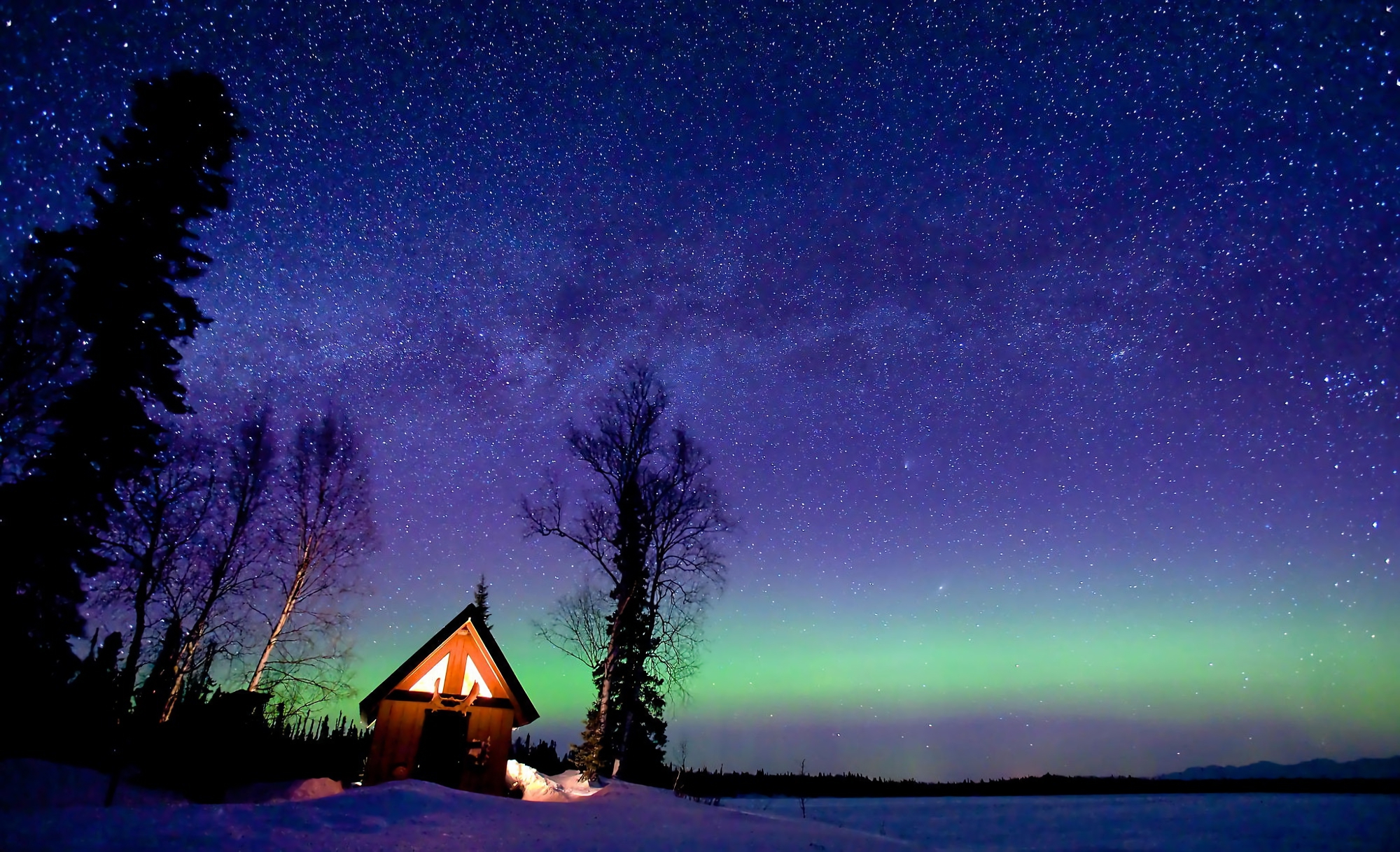 Starry Sky over Winter Cabin