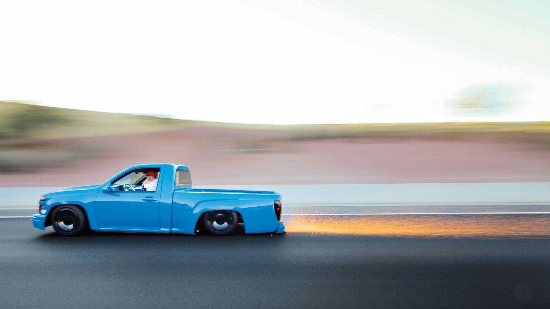 Download Blue Dropped Truck In Motion Wallpaper
