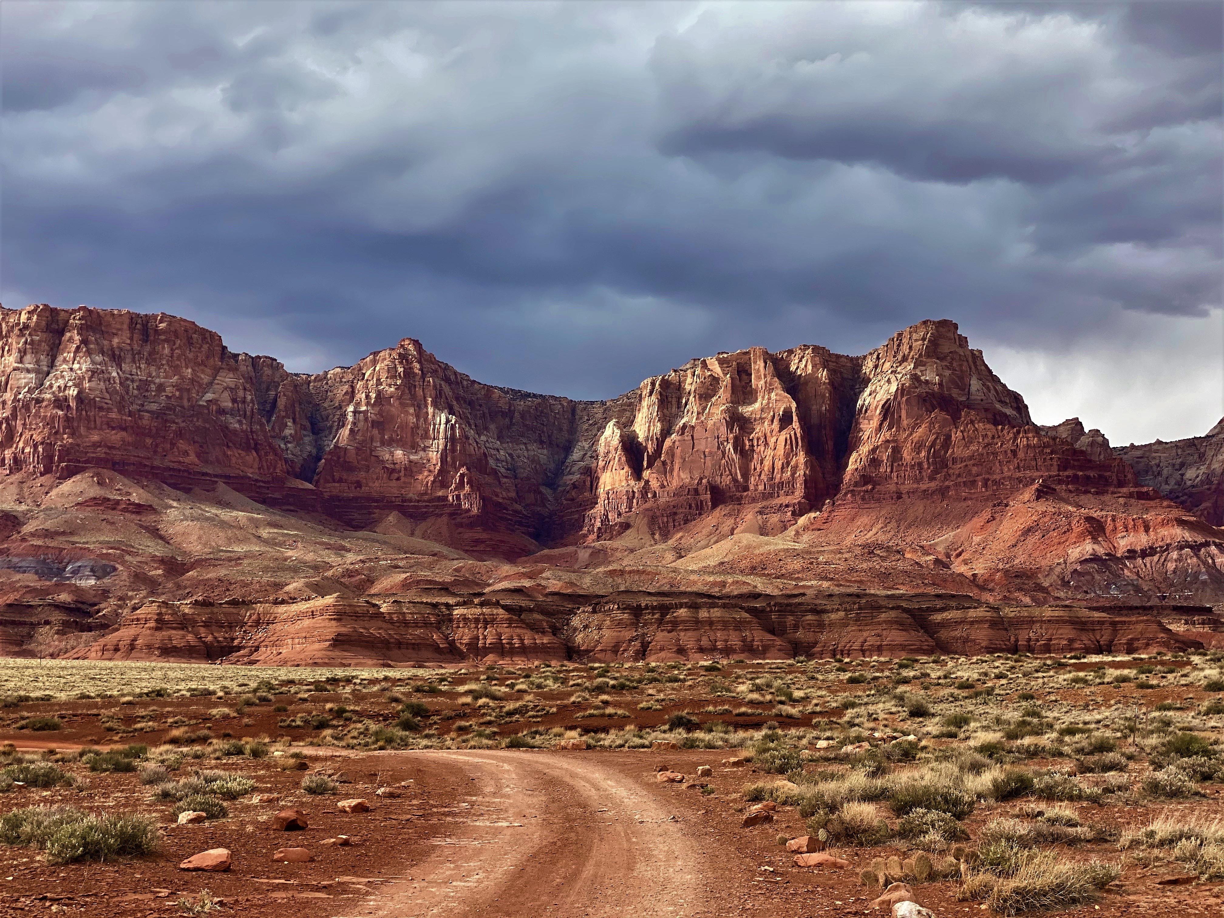 The Vermilion Cliffs beyond Lee's Ferry, past the walls of Marble Canyon, and towering above the grassy plains that hug the edges of the Grand Canyon's majestic and stunning beginnings;