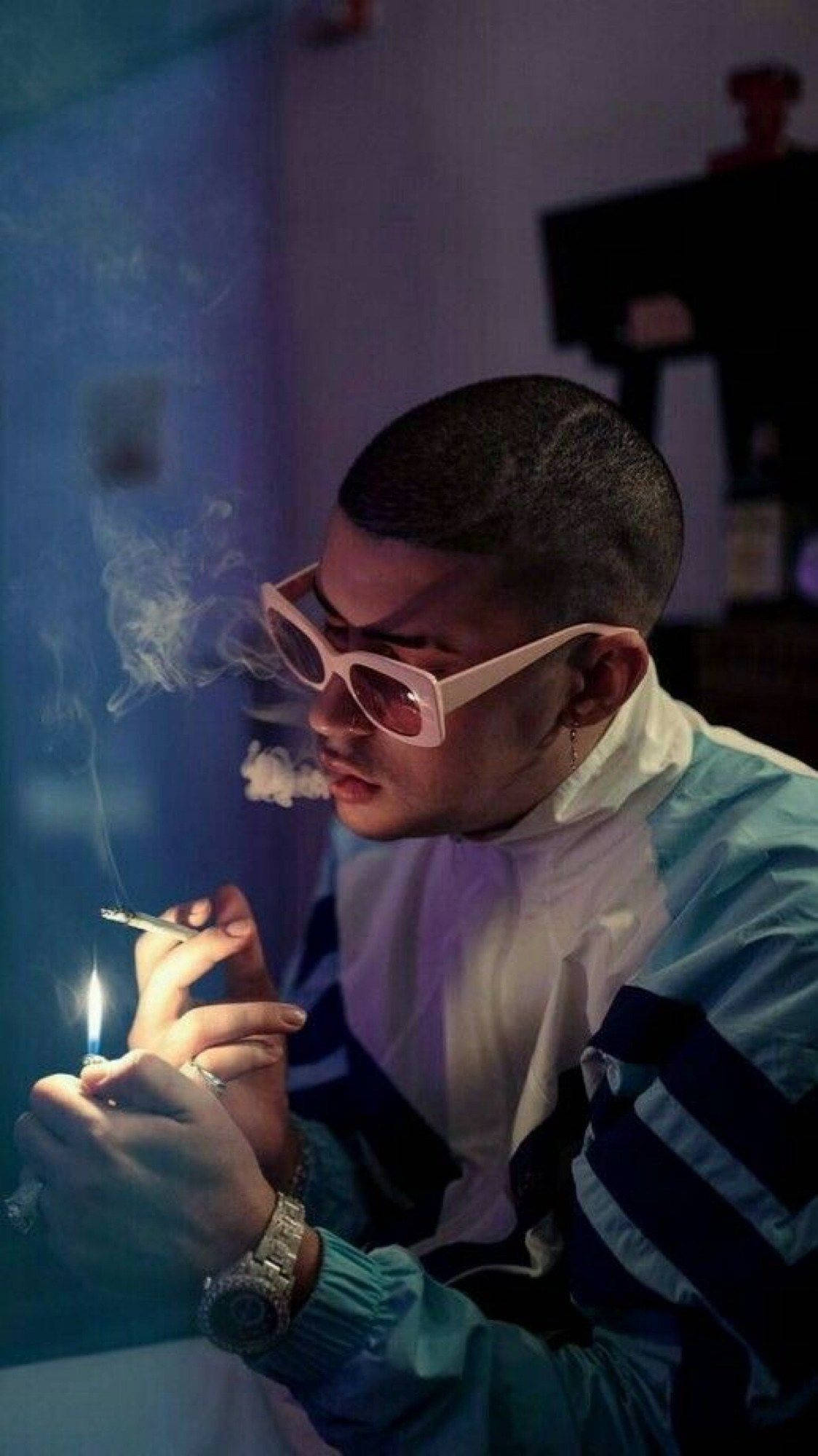 Download Bad Bunny Lighting A Cigarette Wallpaper